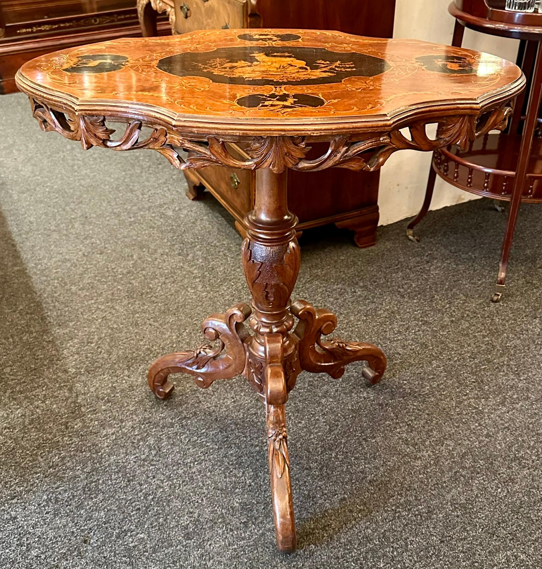 Antique German Black Forest wood-carved hunt table & 2 chairs, circa 1880-1890. Intricate carving and inlay with forest scenes.
2 chair measurements: Height - 37 inches, width - 18 1/4 inches, depth - 15 inches, seat height - 18 inches
1 table