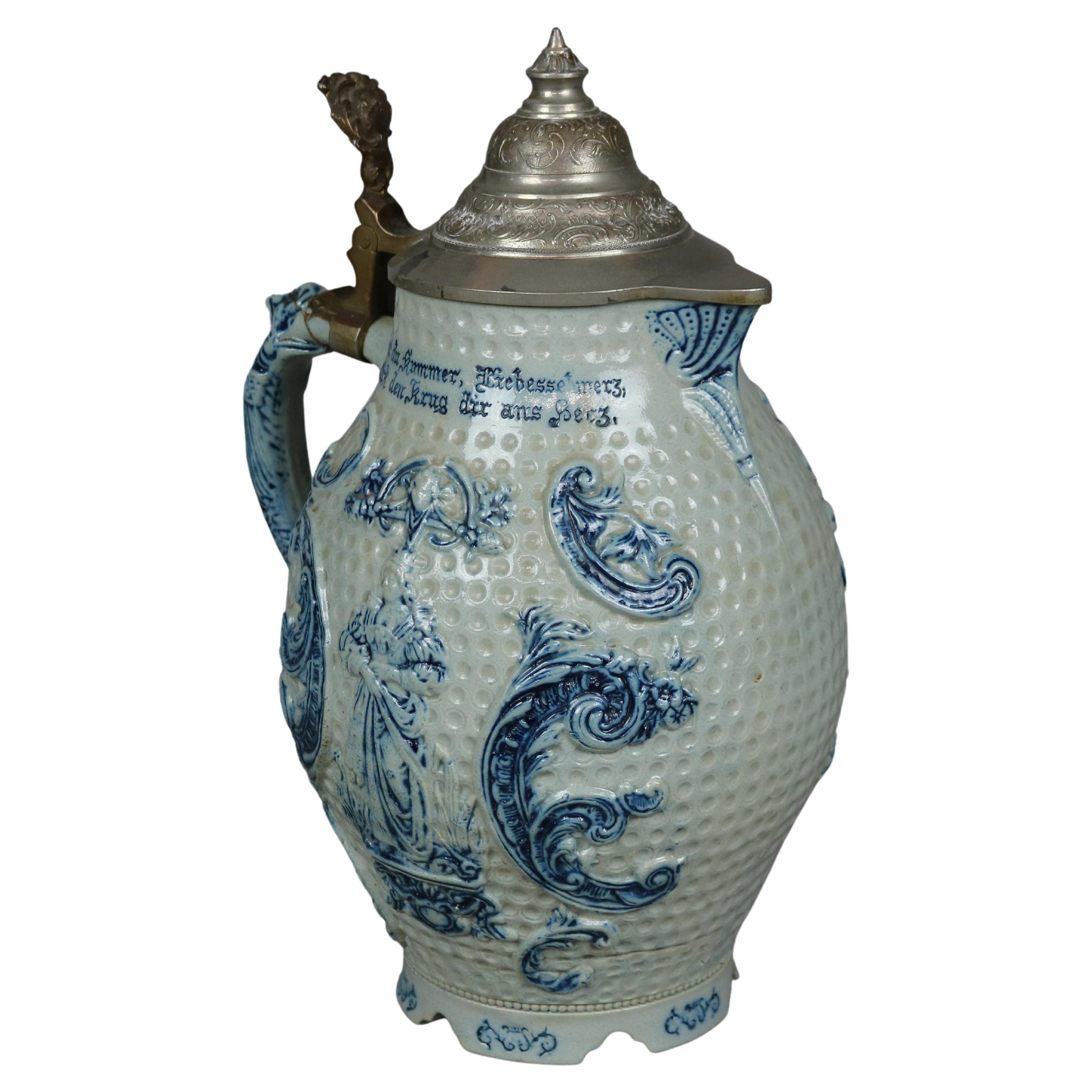 An antique German blue decorated beer stein offers dimpled stoneware construction with female figures, verbiage, hinged pewter lid and non-working music box, c1900

Measures- 13''H X 8.5''W X 8.5''D.

Catalogue Note: Ask about DISCOUNTED DELIVERY