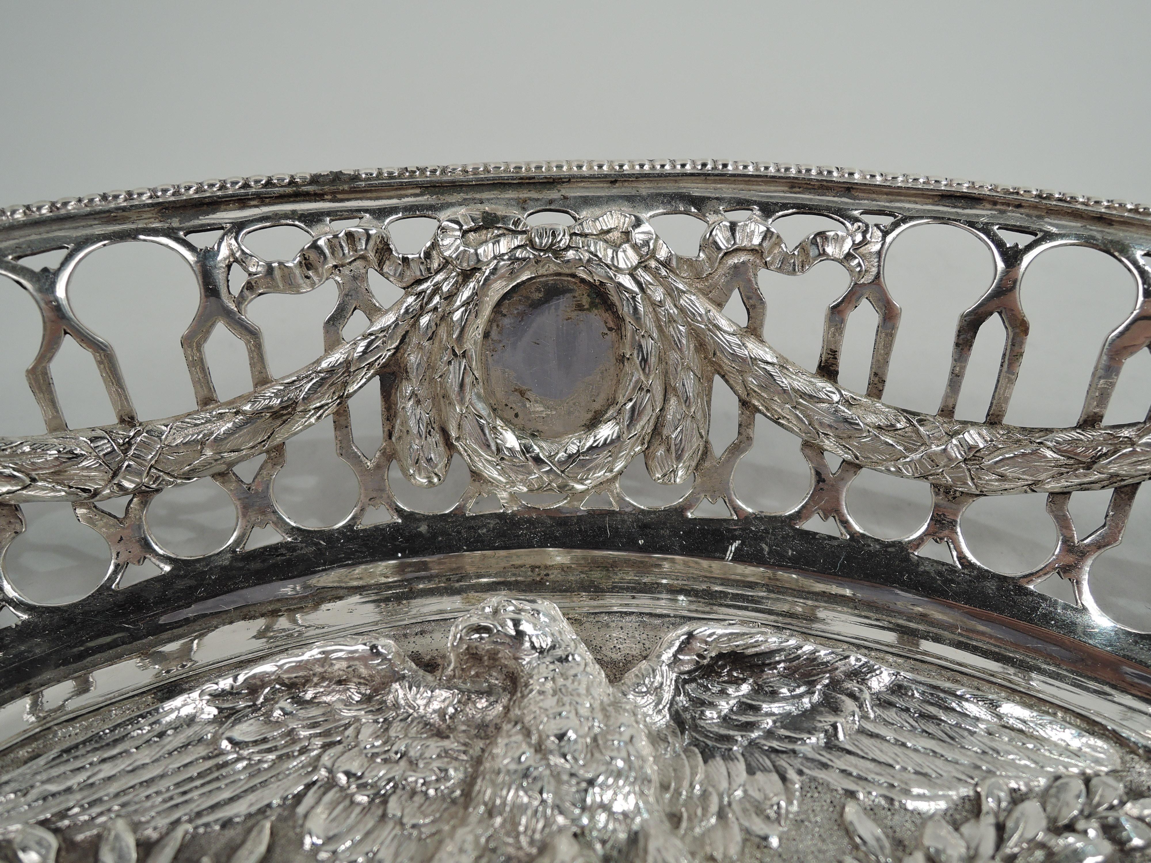 German 800 silver bowl commemorating Napoleon I and Marie-Louise. Lobed quatrefoil with embossed medallion bust portraits of the couple surmounted an eagle; at bottom a military trophy. Open sides with leaf swag with pendant ribboned medallions