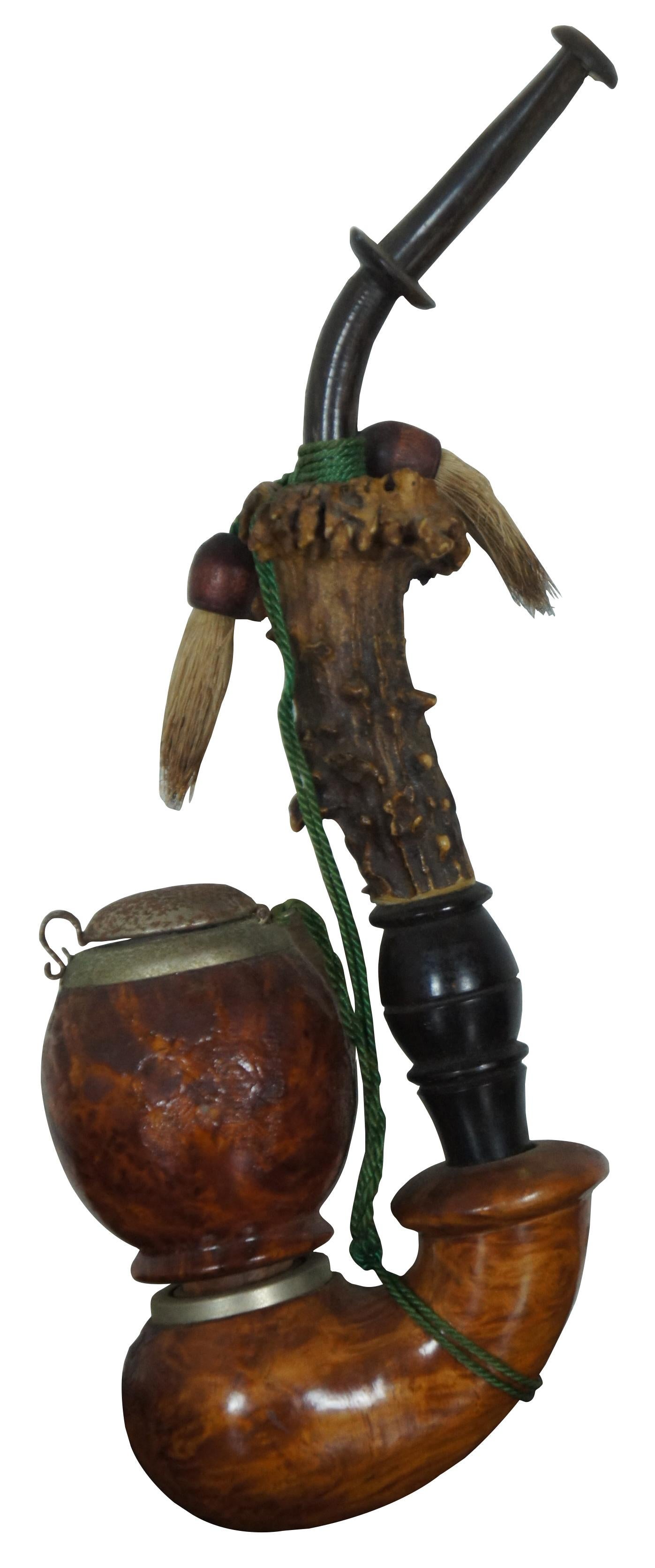 Vintage German smoking pipe fashions with a raw buck horn / antler stem and a round burl wood bowl with metal cap.
      