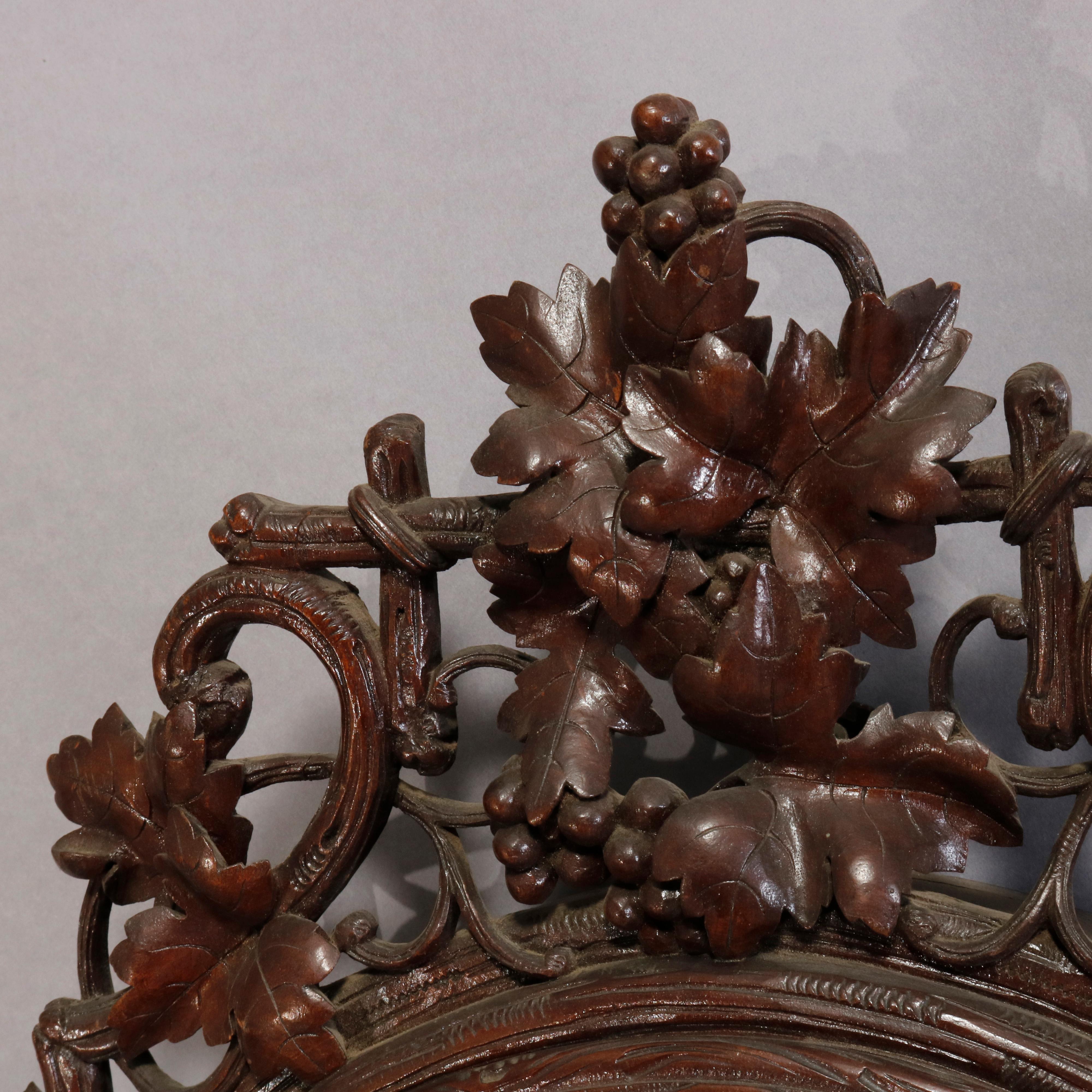An antique German Black Forest wall clock offers frame with carved grape, vine and trestle crest and apron on case with carved gadrooned bordering, circa 1890

Measures: 23.5