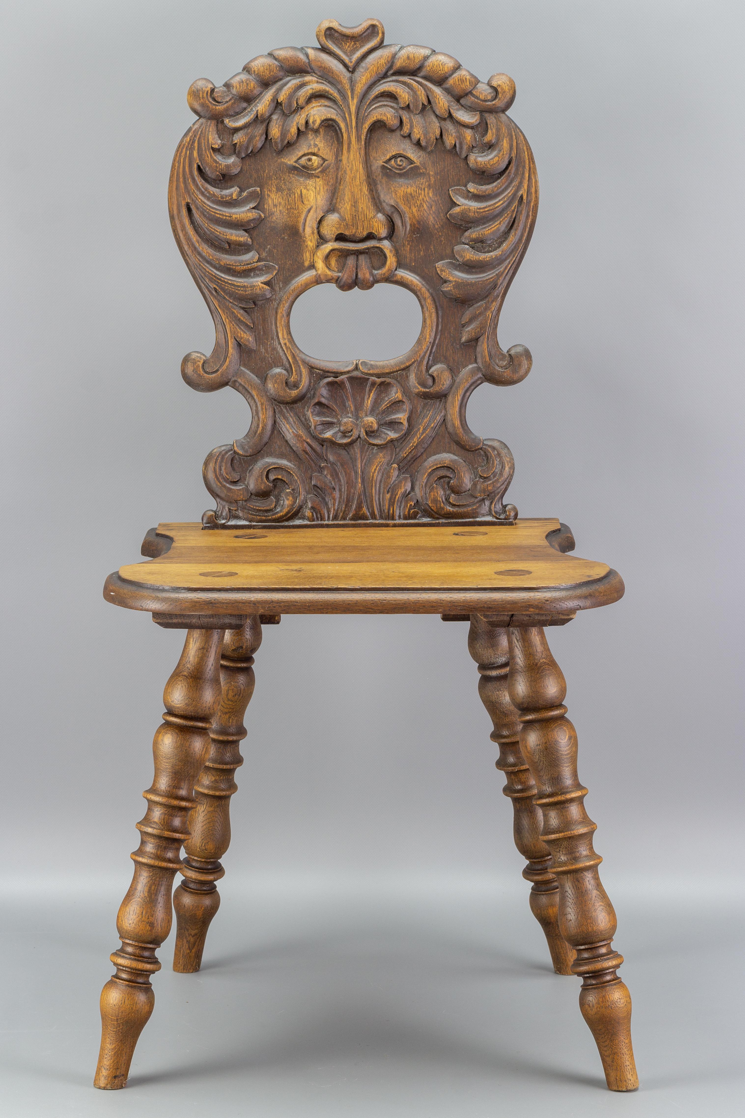 An exceptional carved oakwood peasant chair from the late 19th century. The backrest is highly decorative, adorned with a relief carving of a grotesque. Raised on turned legs.
Dimensions: height: 90 cm / 35.43 in; width: 47 cm / 18.5 in; depth: 42