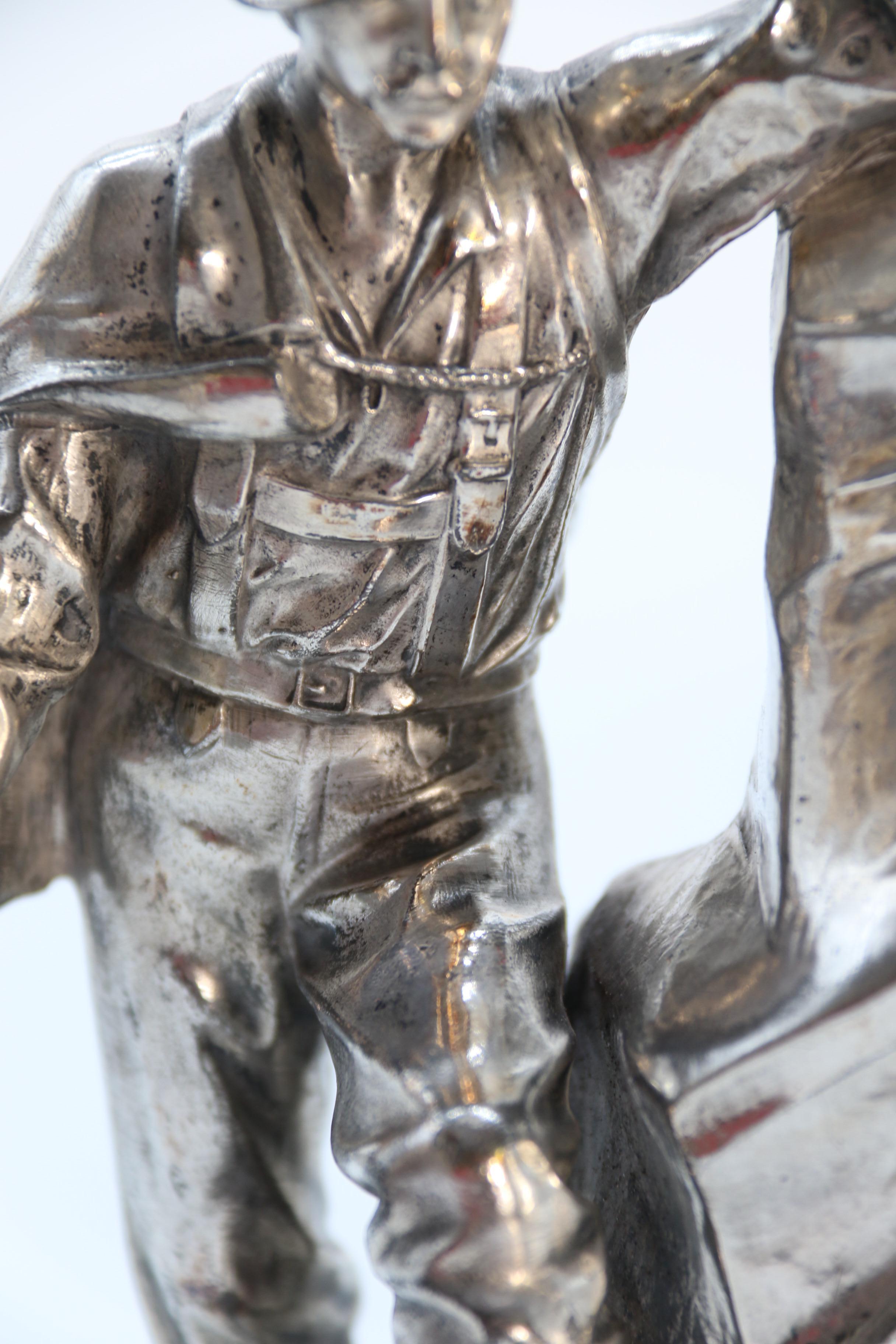 Antique German cast metal and silver plated sculpture of a mountaineer C 1910 13