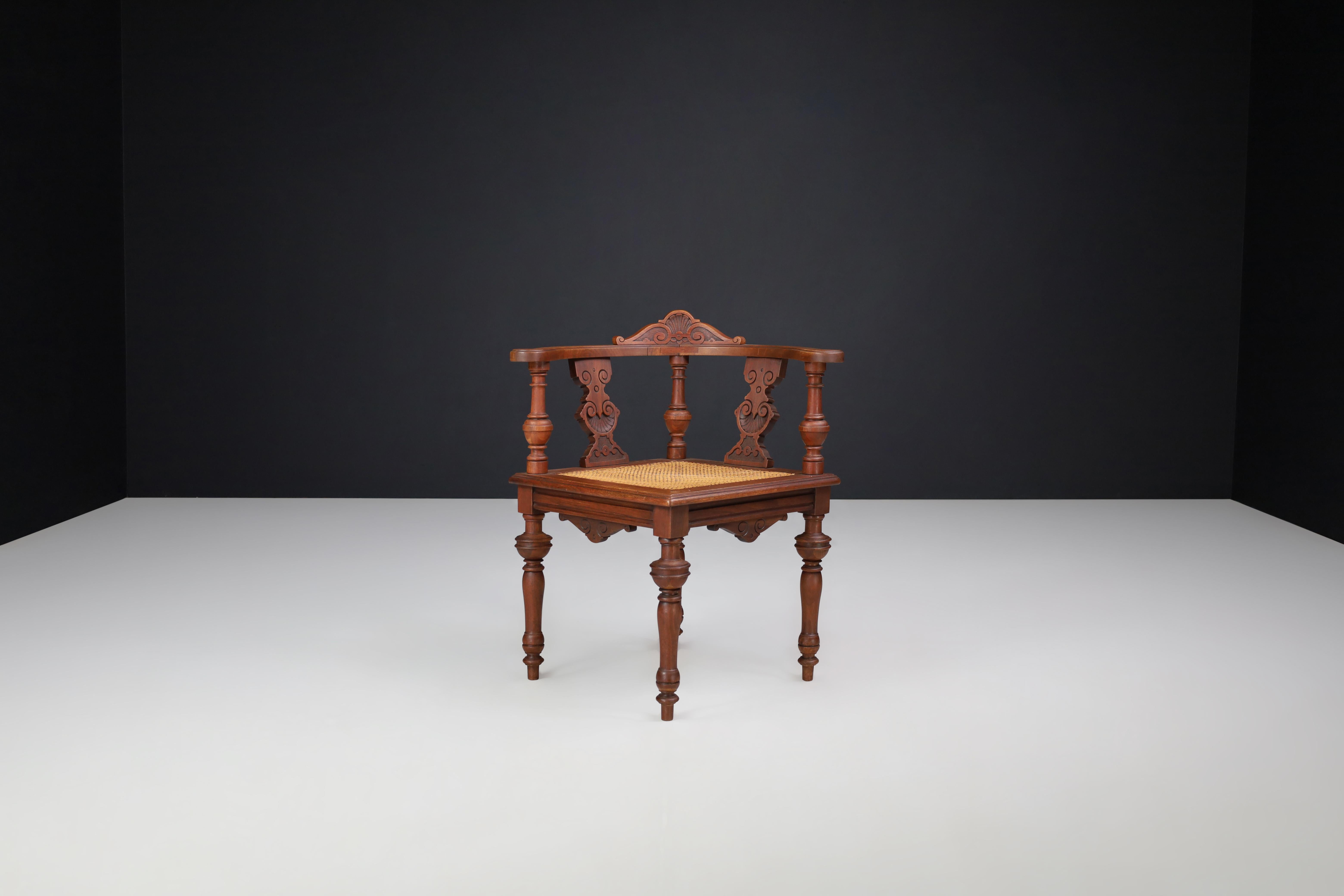 Antique German Corner Chair, Circa 1880 – Hand-Carved Walnut with Cane Seat

A refined example of late 19th-century German craftsmanship, this antique corner chair, dating to circa 1880, showcases the elegance and artistry of the period. Constructed