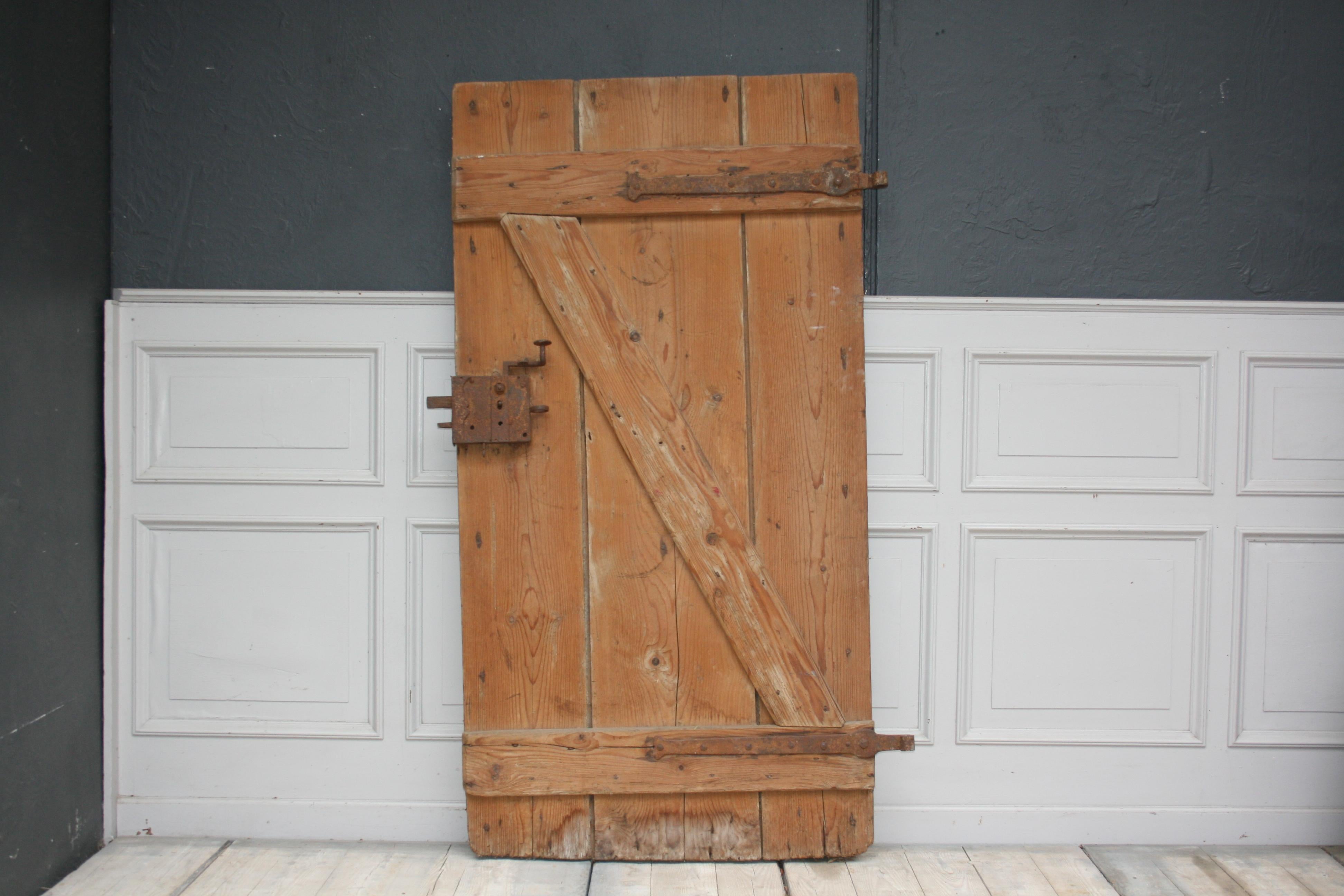 Decorative original antique door. The side of the door that was originally visible to the outside, is made of solid oak and the other side of the door, the inside of the house, is made of fir wood and has a kind of 