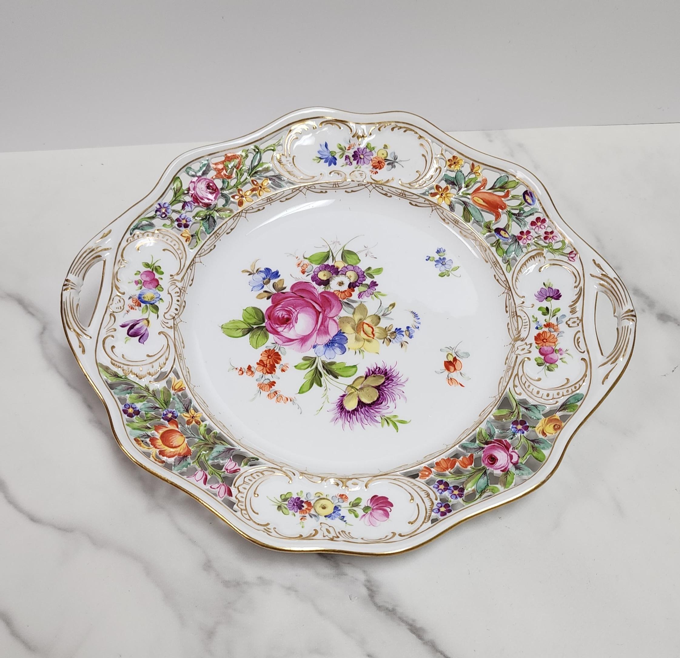This beautiful antique porcelain cake plate is by Carl Thieme for Dresden China. The intricate reticulated cutouts at the handles are expertly done while the hand painted floral garden pattern is still bright and vibrant.
 
The Sächsische
