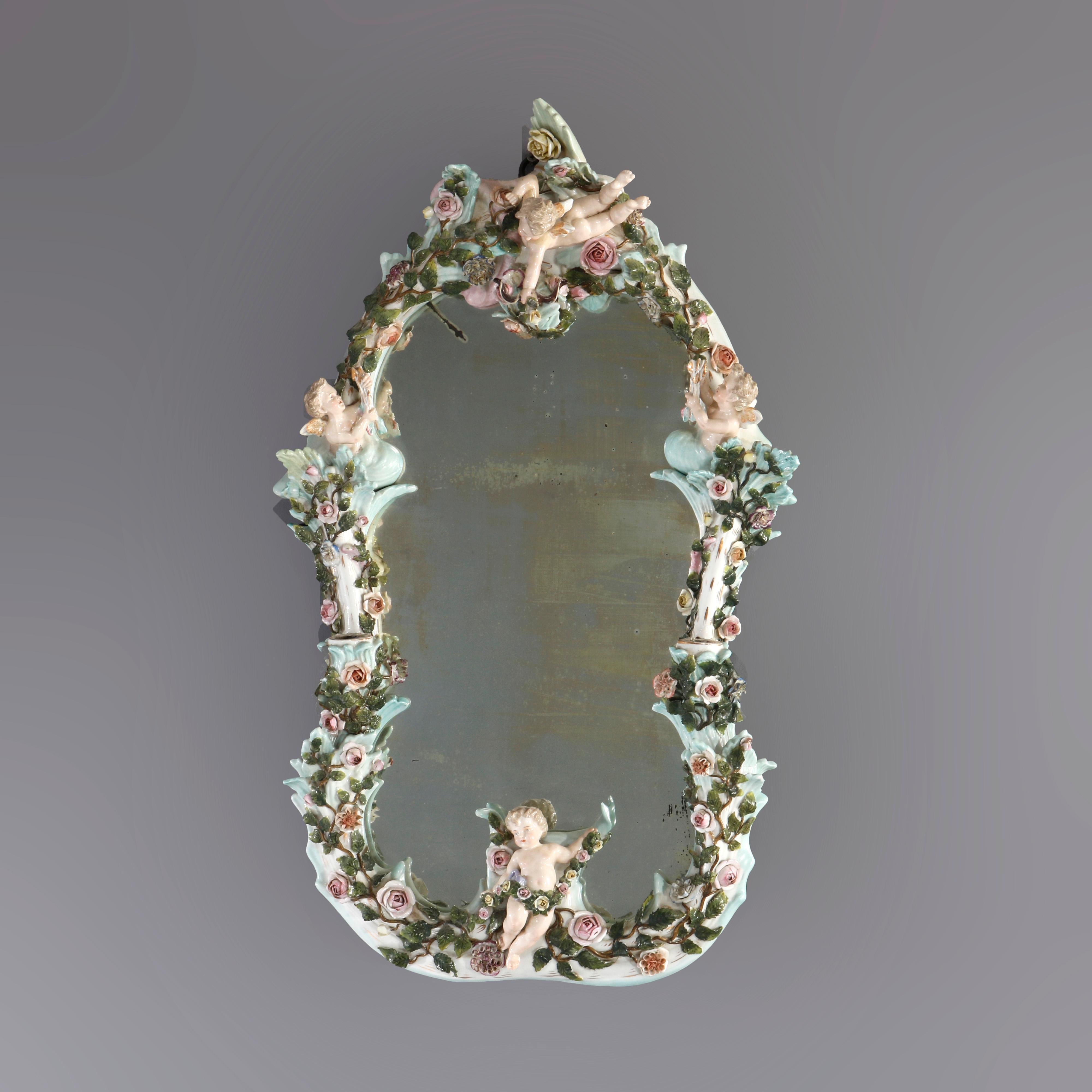 An antique large German Dresden figural wall mirror offers hand painted porcelain frame with cherubs, flowers and flanking candle sockets, 19th century

Measures - 27'' H x 16.5'' W x 4.5'' D.

Catalogue Note: Ask about DISCOUNTED DELIVERY RATES