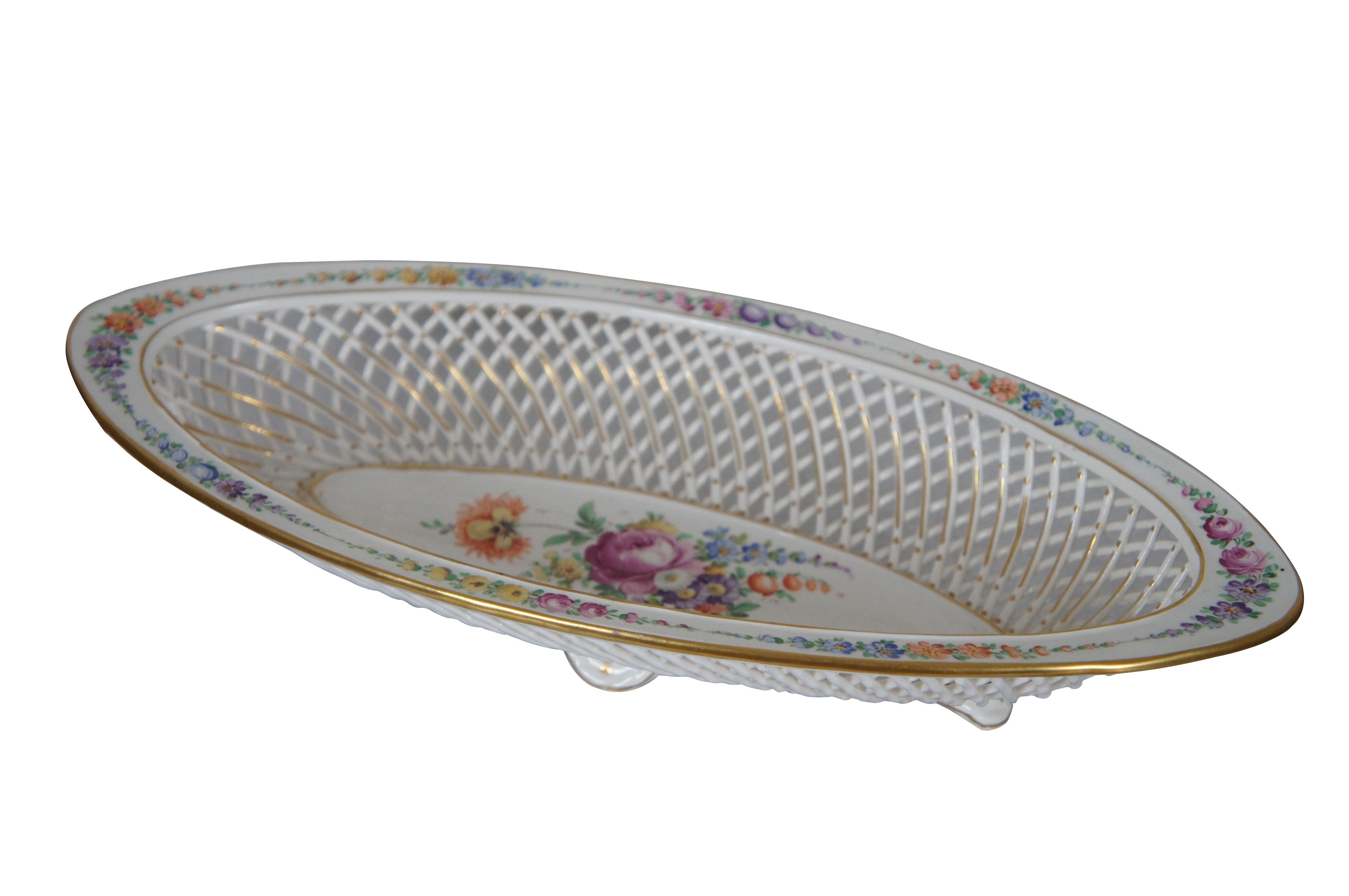 Large antique Dresden Germany crown mark bowl or compote. Made of porcelain featuring oval form with reticulated basketweave pattern, footed base and colorful floral motif.

Dimensions:
12.5