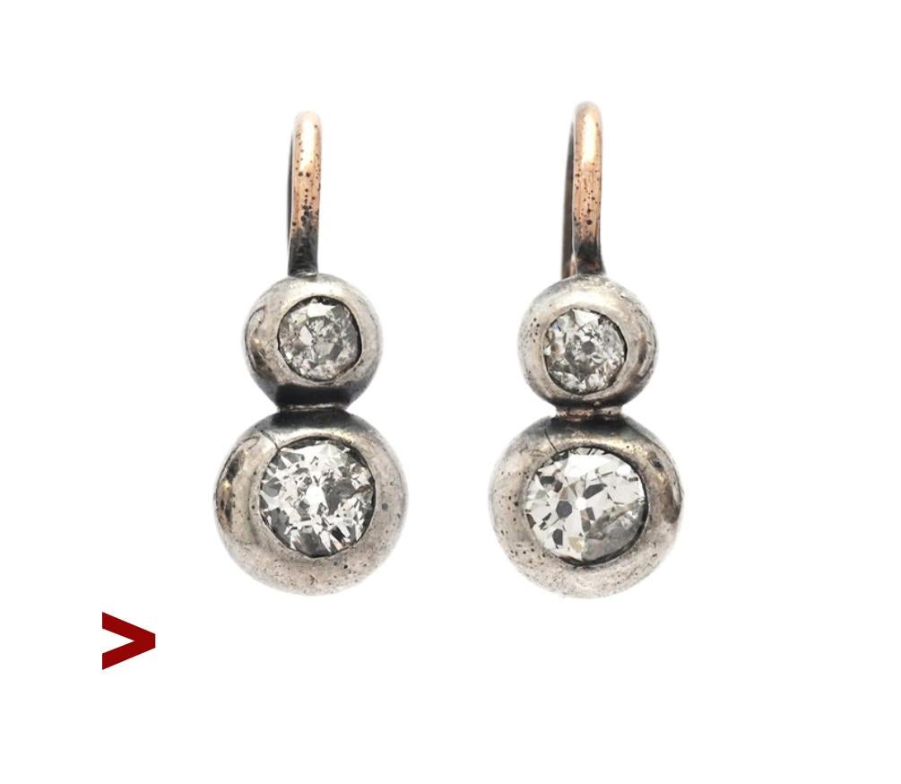 A pair of old German Diamond Earrings with folding hooks from ca 1920s - 1930s.

No hallmarks, and apparently custom-ordered. Metal tested 14K, clusters in Silver. Each earring is 17 mm long including the hooks.

All Diamonds are naturals of old