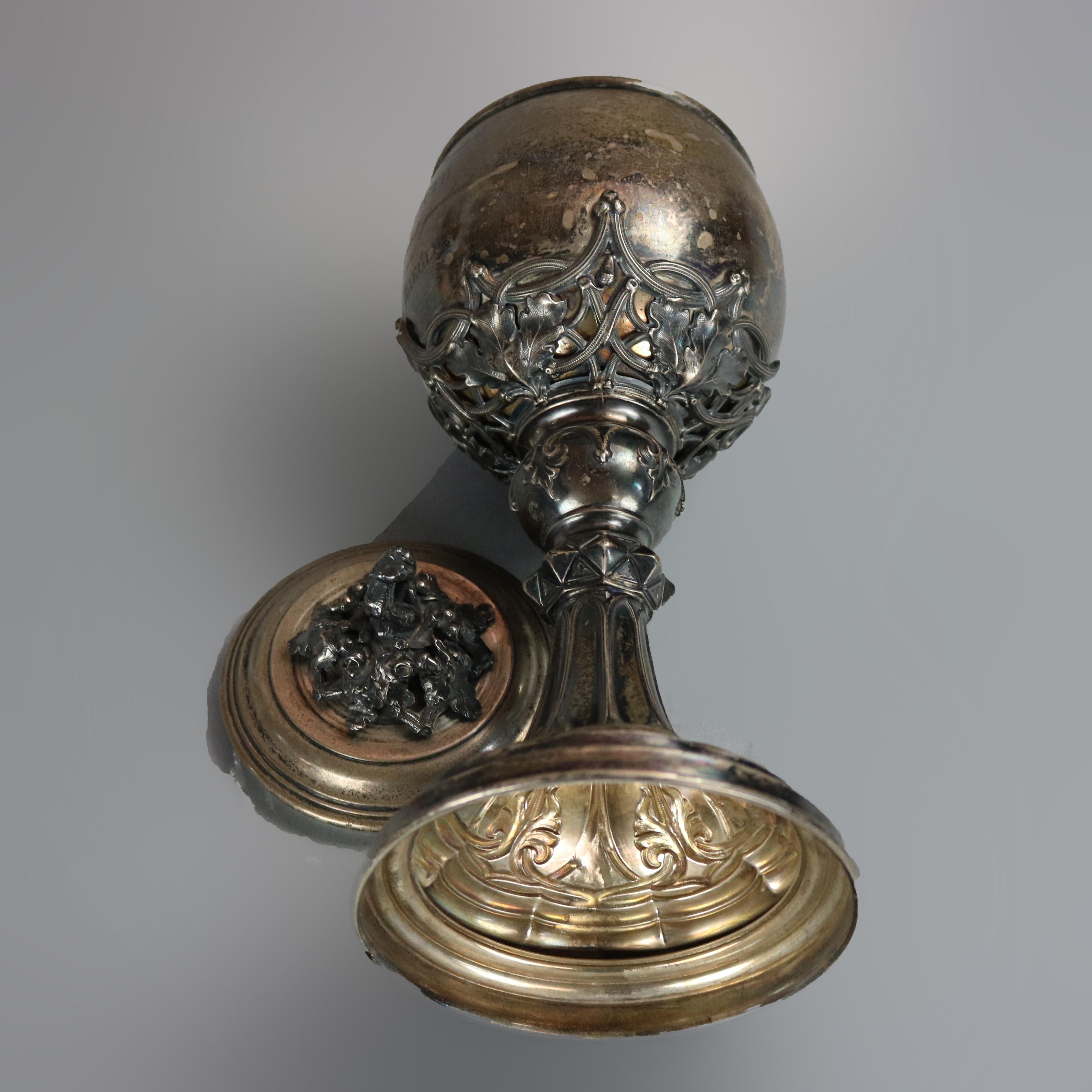 An antique German ceremonial chalice offers coin silver construction with cast oak leaf and branch form lid finial, bowl with gold wash interior and supported by scroll and oak leaf engraved, circa 1860

Measures: 11.75