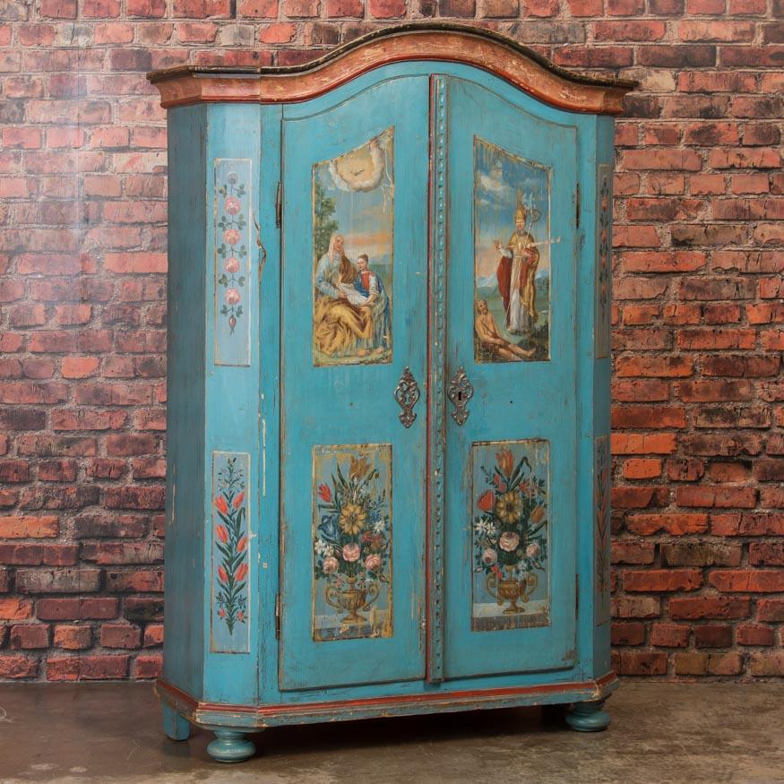 This is a truly outstanding Folk Art painted armoire due to the high quality and detail of the original paint. The delightful religious and floral motif with soft, gentle colors are unusual in both detail and quality. Please examine the close up