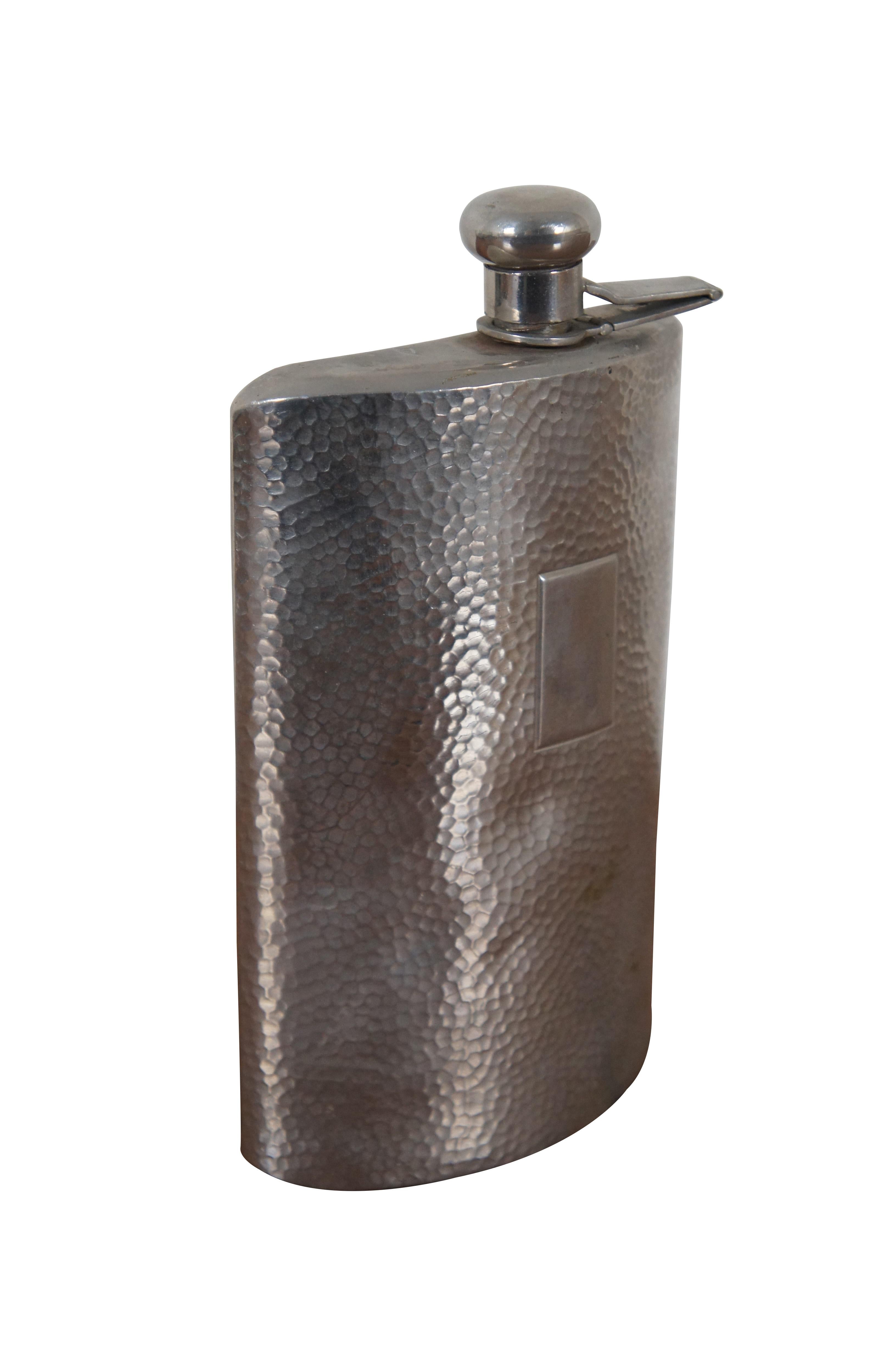 Antique hammered silverplate large hip flask with cork lined flip top and rectangular panel on the front for a monogram. Marked Germany on base. Triangular mark on lid hinge.

Dimensions:
3.75