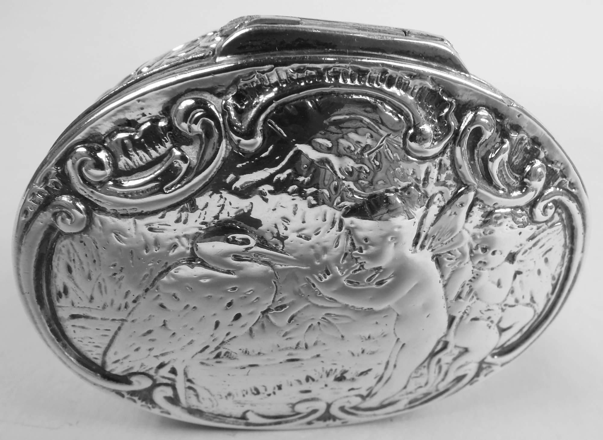 German Rococo 800 silver snuffbox, ca 1910. Oval with hinged cover; on top is chased scene depicting a large bird confronting two cherubs with soft chubby bodies and ethereal wings. Probably an allusion to some or other episode in Classical