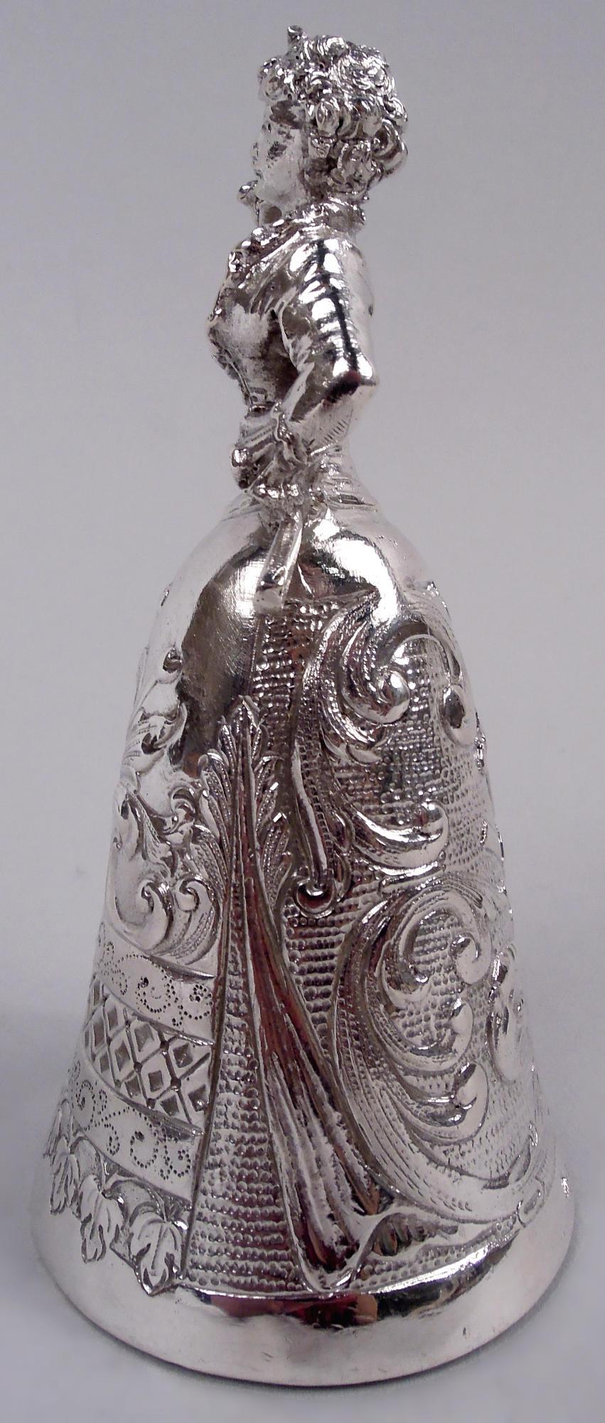 German Rococo 800 silver figural bell in style of wedding cup, ca 1910. Tightly laced, bosomy Jungfrau holds a loft a bouquet; other hand casually rests on hip, while gripping fan. Conical skirt bowl with chased and stippled leafing scrollwork and
