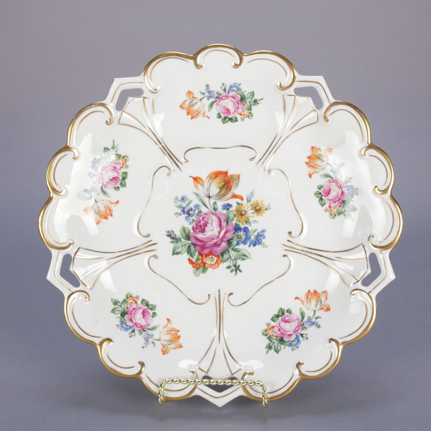 An antique German hand enameled porcelain charger by Henneberg-Porzellan features stylized flower form with floral reserves and gilt highlighting throughout, en verso maker stamp and numbered, circa 1920.


Measures: 1.5