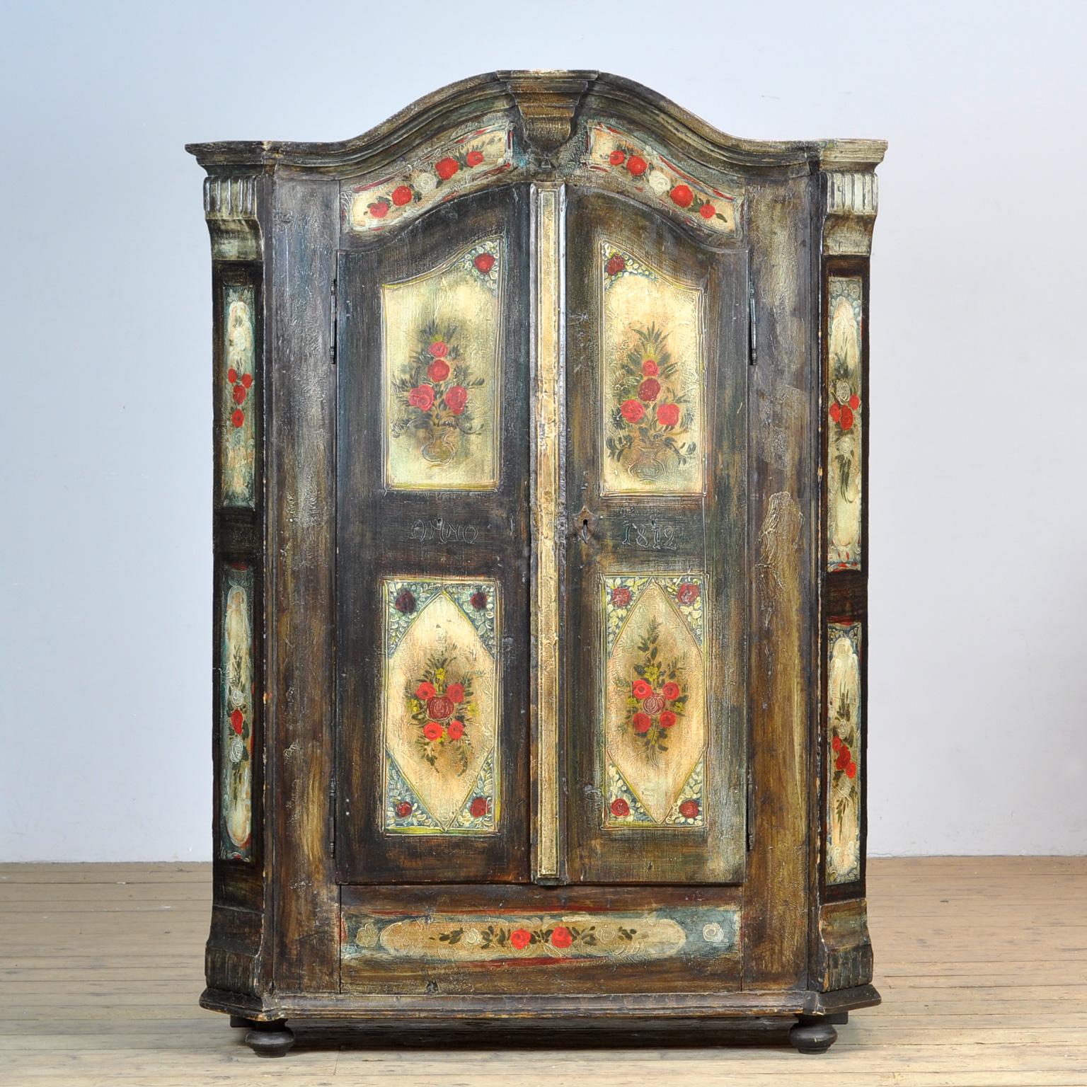 A beautiful cabinet from the rural south of germany, dating from 1812. The cabinet was probably given as a wedding present. This cabinet is made of solid pine and is hand painted in vibrant colors. The cabinet has kept its original hinges and lock.
