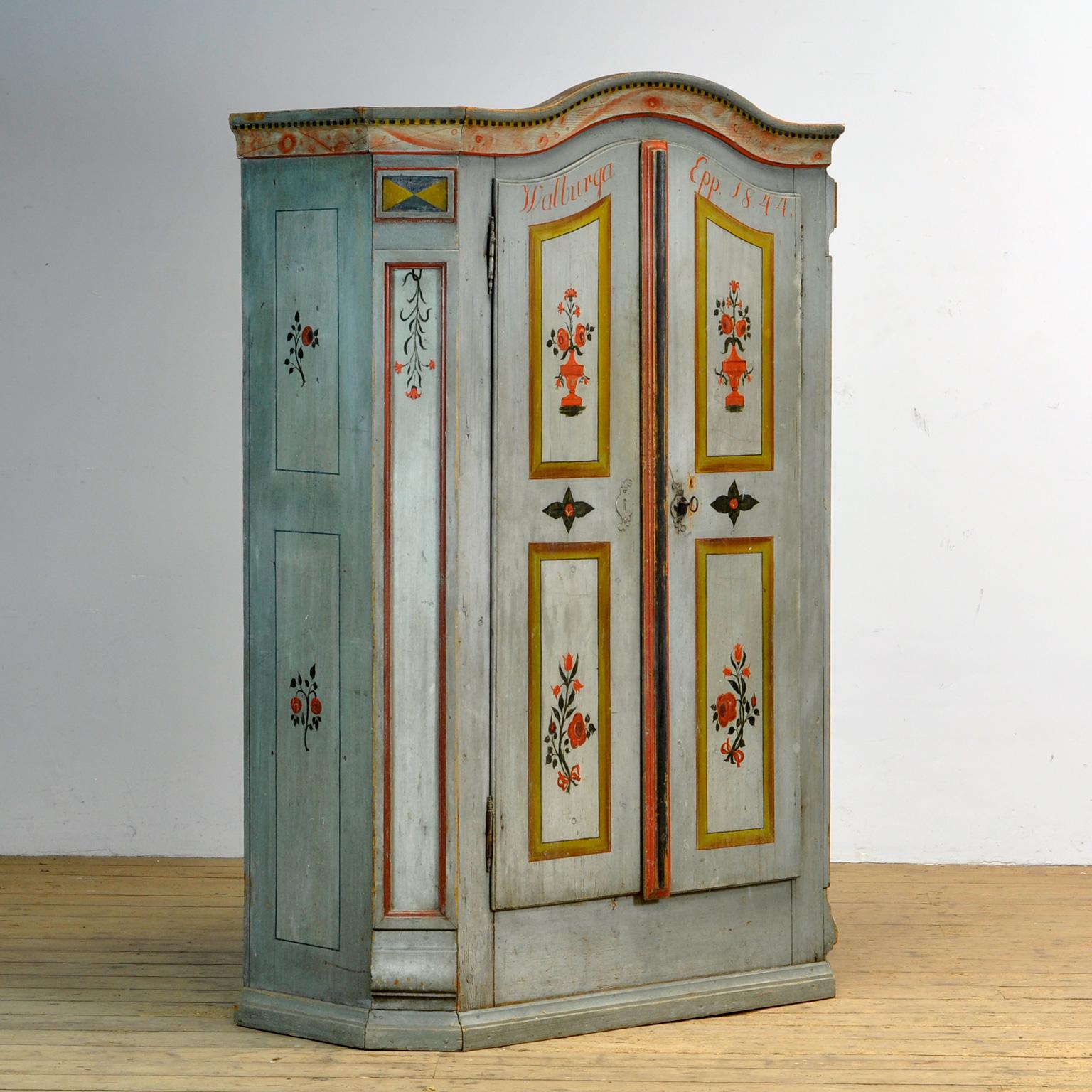 A pine cupboard from rural southern Germany, dating from 1844. The cupboard was probably given as a wedding gift. This cabinet is made of solid pine and is hand-painted in vibrant colors. 2 drawers on the inside, 3 shelves on the left and a rod on
