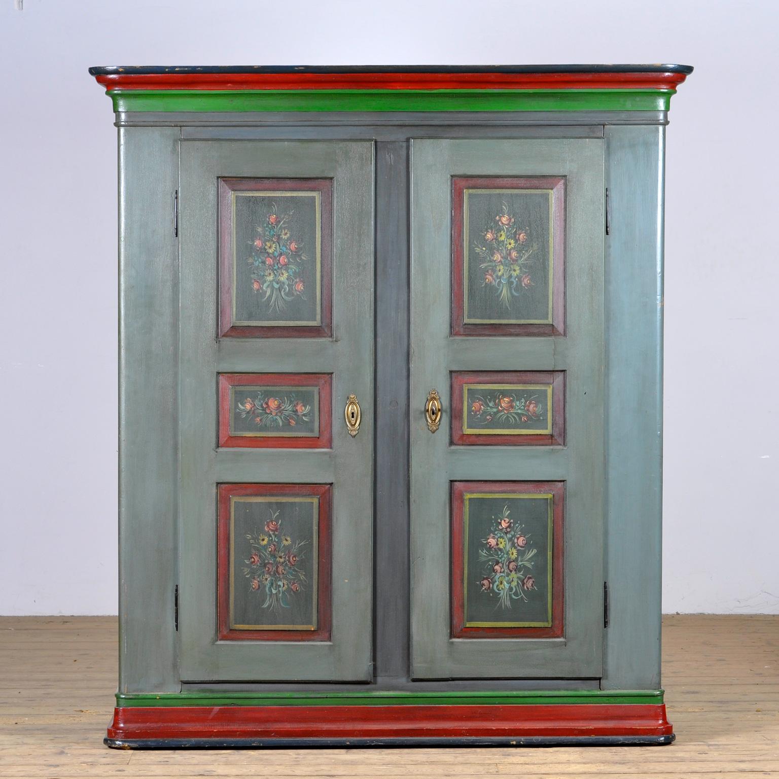 A beautiful cabinet from the rural south of germany, dating from circa 1850. The cabinet was probably given as a wedding present. This cabinet is made of solid pine and is hand painted in vibrant colors. The cabinet has kept its original hinges and