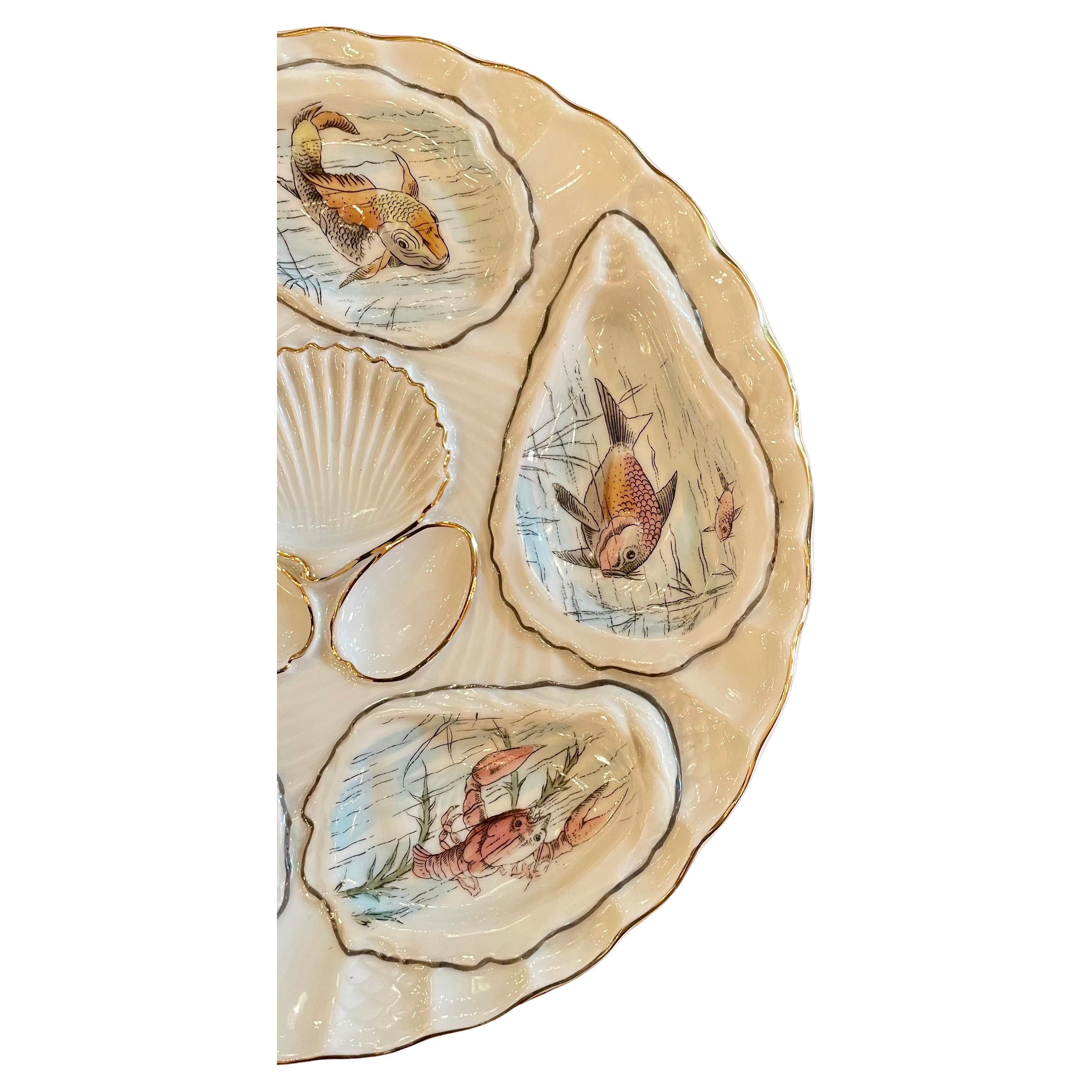 Antique German Hand-Painted Gold Porcelain Oyster Plate with Sea Life, Circa 1890.
Various Sea Grasses and Sea Creatures on a white background with gold work details.