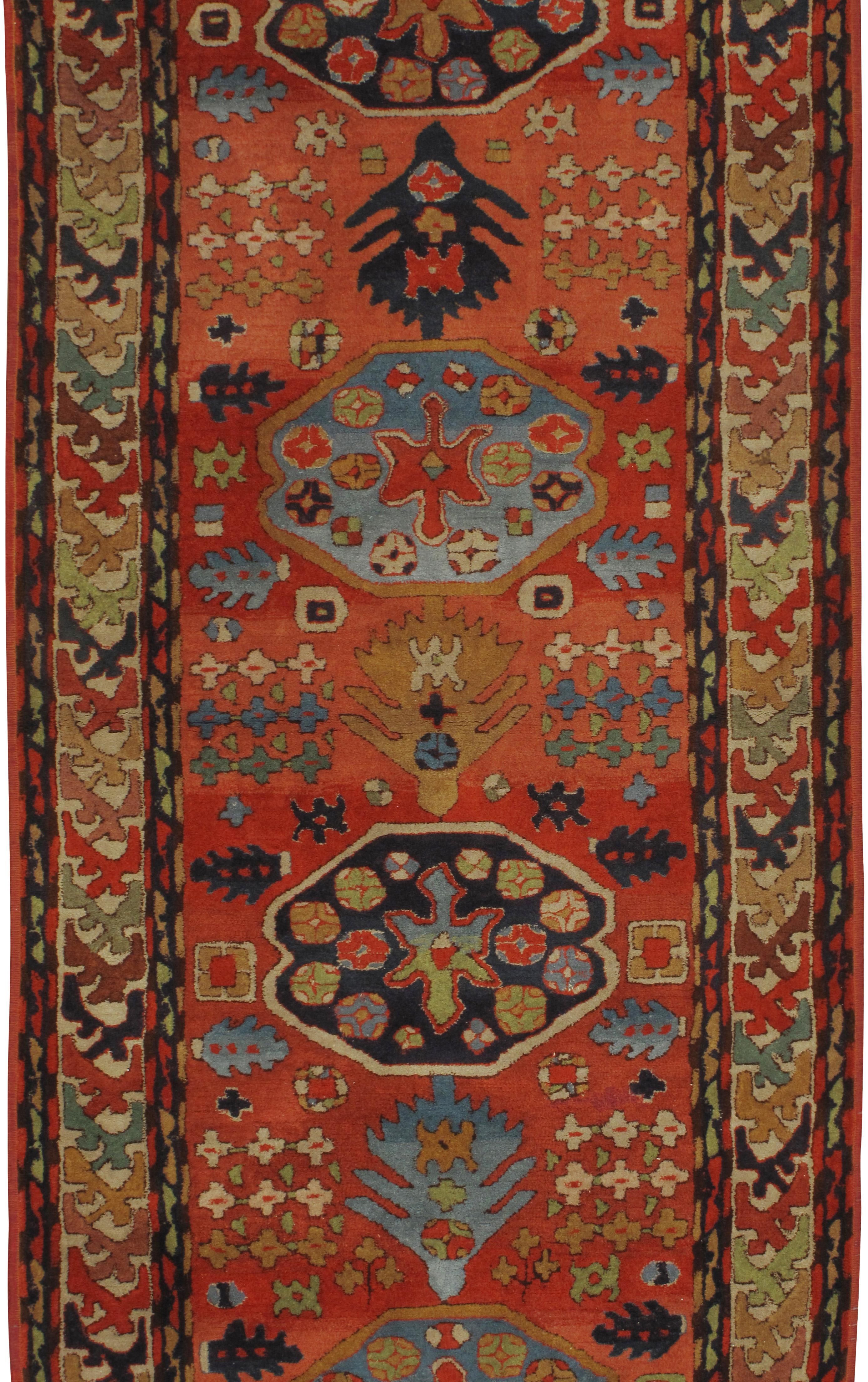 Antique German hooked runner rug, circa 1900. An antique German hooked rug with a traditional Indian Agra design in a soft watermelon color with blues and greens. This is a rare example of hooked rugs from Germany. Size: 3'1 x 12'2.
