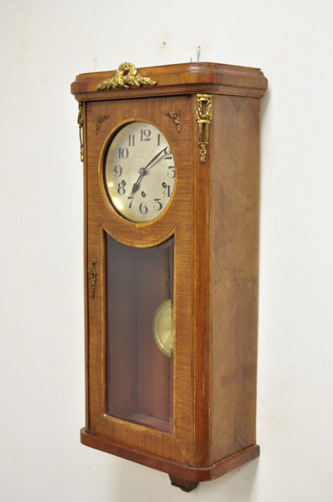 Antique German Inlaid French Style Box Wall Clock 8 Day with Westminster Chime. Item features Bronze ormolu, beveled glass door, includes keys as pictured and paperwork from the last servicing which appears to be in 1997. Please read all supporting