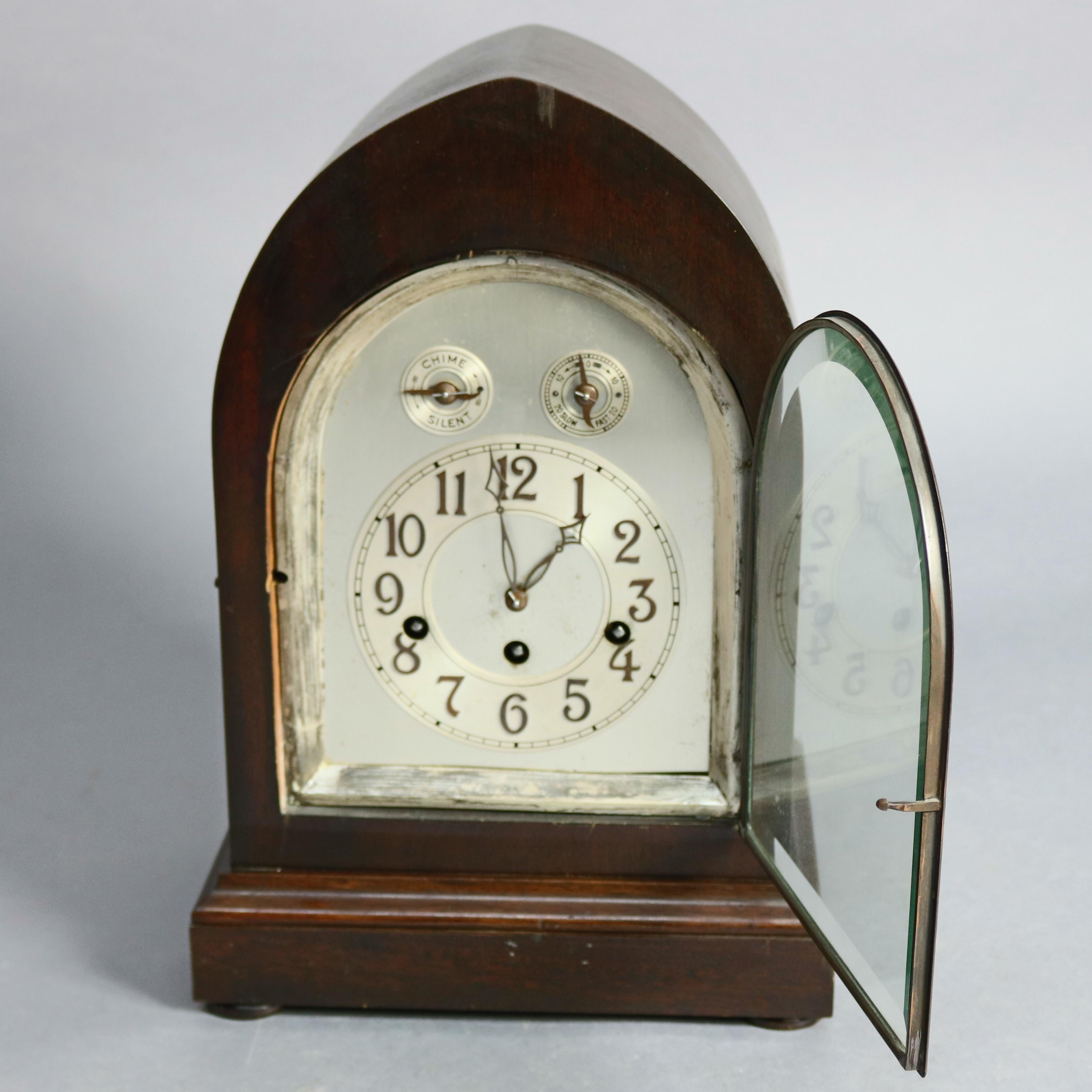 An antique German mantel clock by Junghans offers mahogany case in arch form with face having Arabic numerals, speed dial and chime dial, circa 1920.

***DELIVERY NOTICE – Due to COVID-19 we have employed LIMITED-TO-NO-CONTACT PRACTICES in the