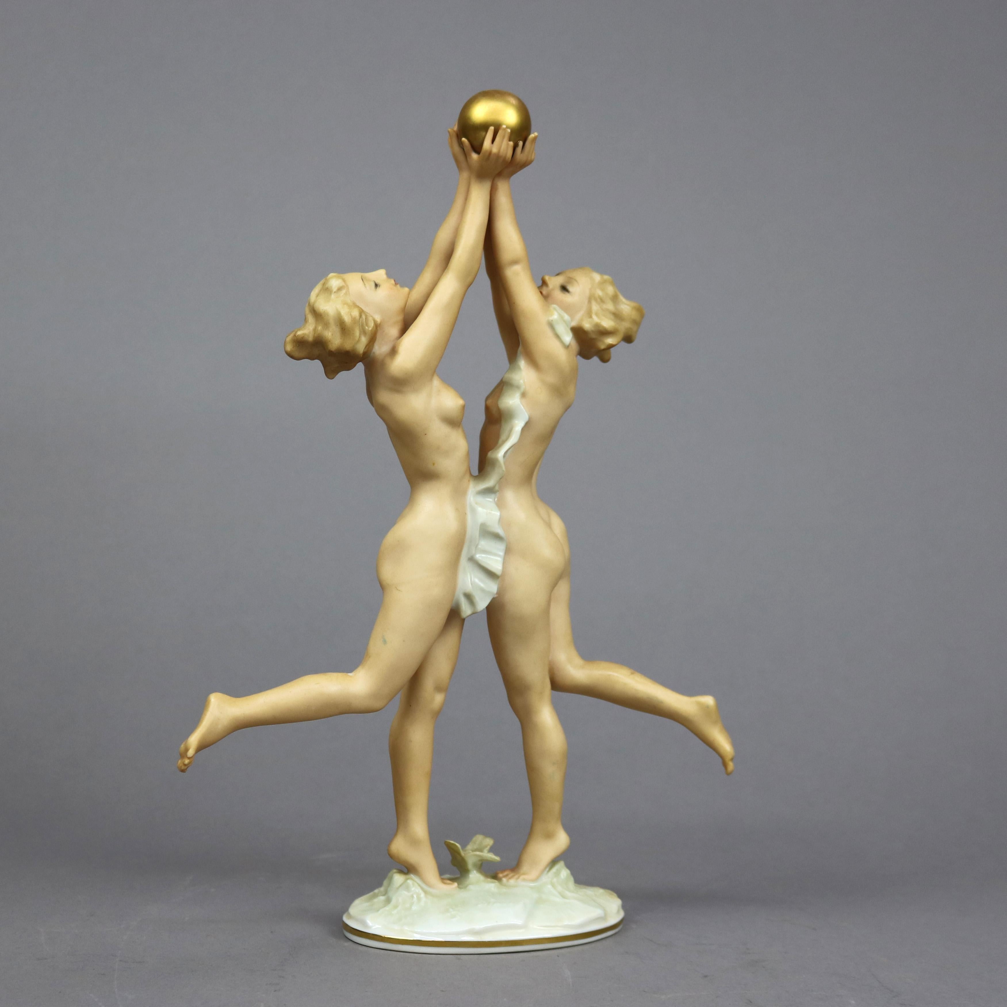 An antique German figure by Karl Tutter of Hutschenreuther offers a hand painted porcelain figural grouping of a dancing nymphs holding gilt ball in woodland setting, maker mark as photographed, c1920

Measures - 12.5''H x 3''W x 8.25''D.