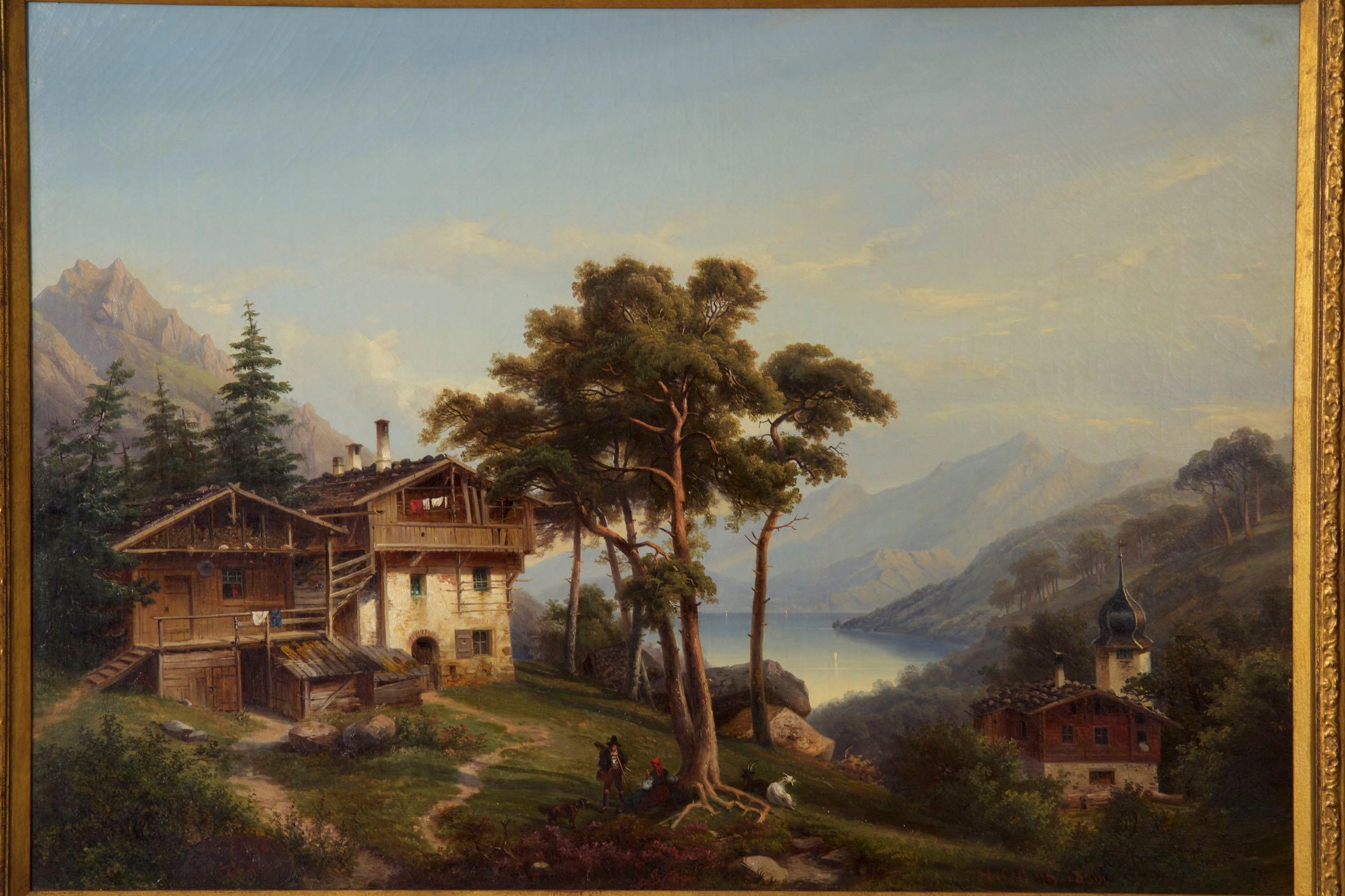An exceptional genre scene of a German landscape under a nearly cloudless sky, a large wood and stone chalet is tucked into a grove of pine trees overlooking the blue lake below. Mountains loom in the distance while a hiker and his dog chat with a