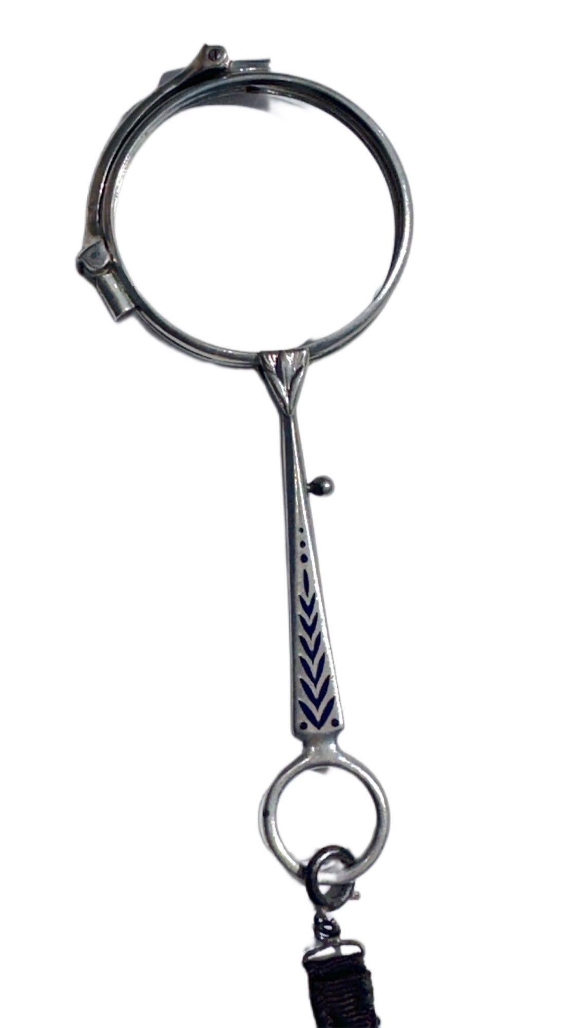 Silver Made in Germany Stamp Lorgnette with Lapis Lazuli Inlay on Handle. Has a quick-release trigger to allow quick access to bifocals. No Glass included.
A lorgnette is a stylish handheld optical accessory that gained popularity in the late 18th