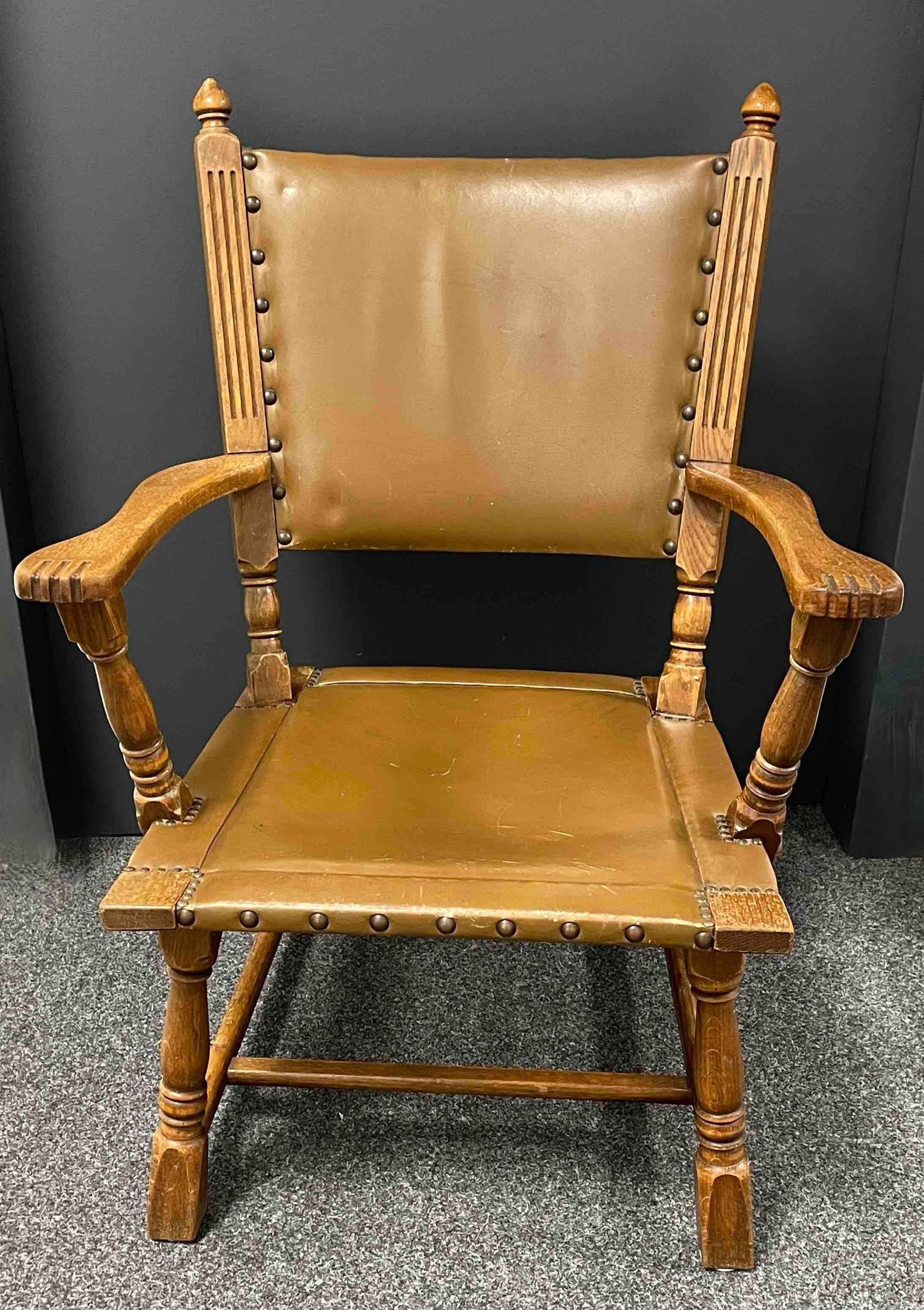 beautiful lounge arm chair made of wood and leather with nailhead details. We think this example is from the 1910s, good condition. Minor patina and scratches on the leather, gives this pieces a classy statement.