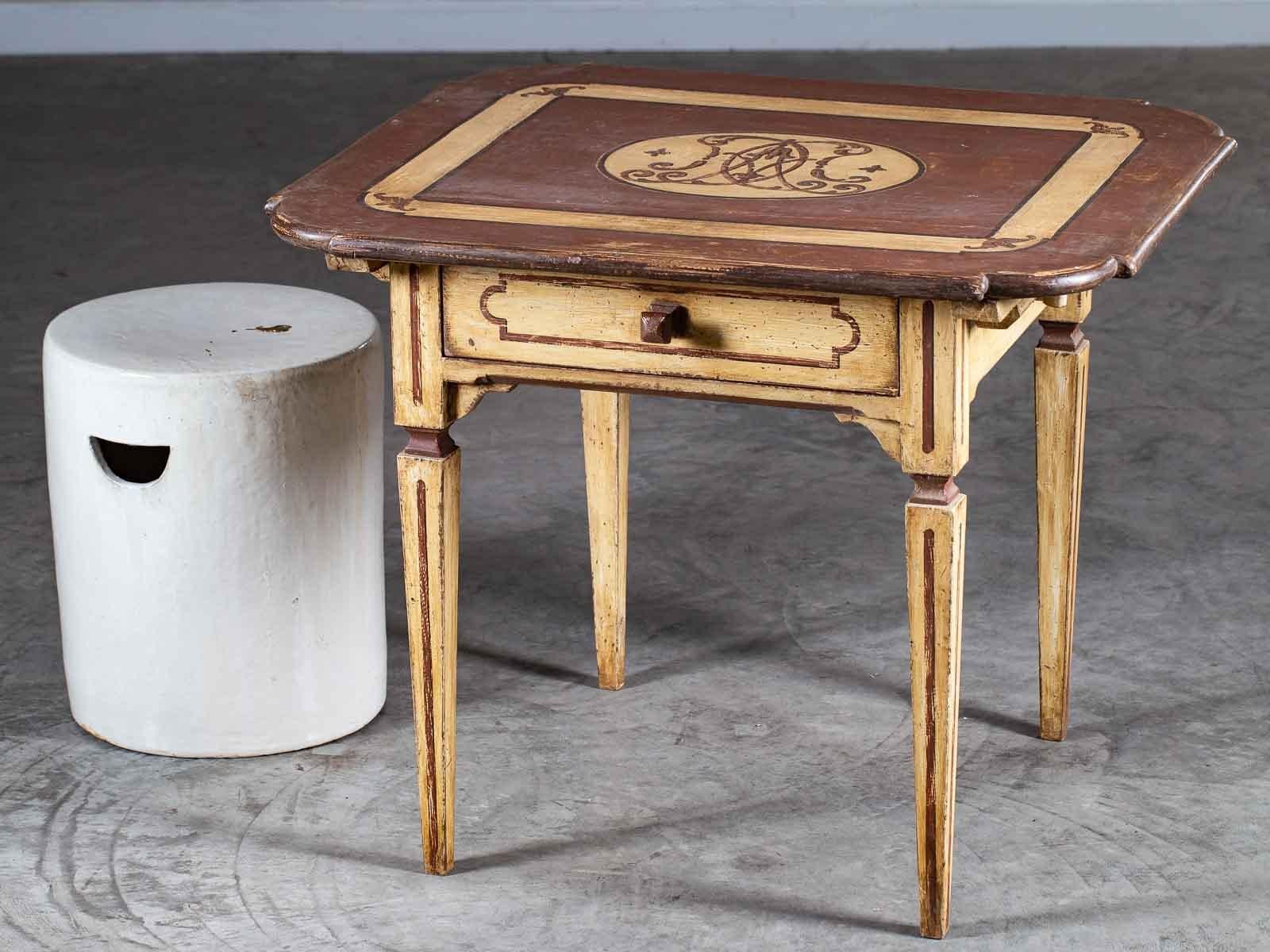 A handsome antique German Louis XVI period painted table circa 1790 having a large drawer. The elegant Neoclassical lines of this table with its straight tapered legs and symmetrically shaped top are enhanced with the refreshed painted finish.