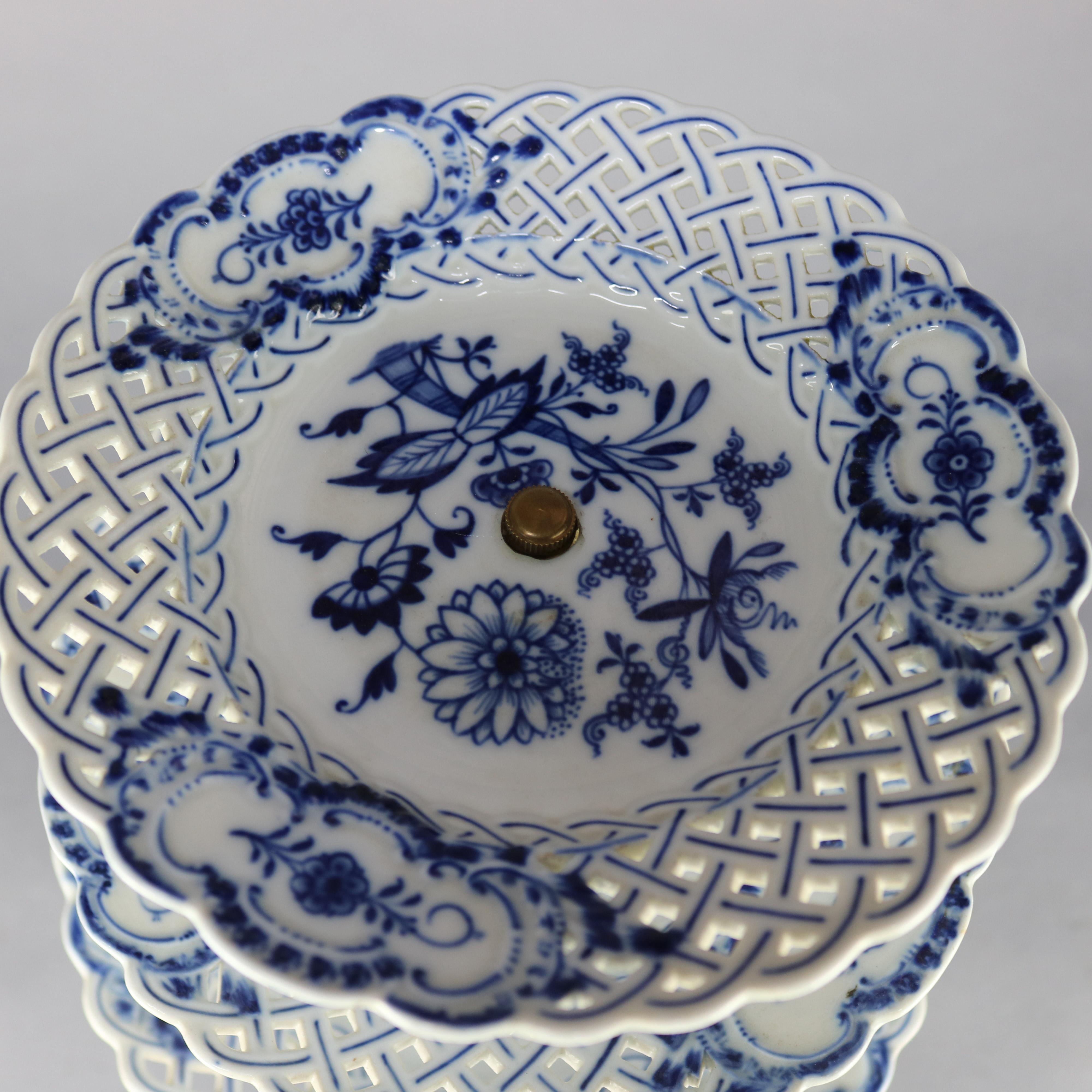An antique German Meissen serving tray offers porcelain construction with blue floral decoration on three reticulated and tiered trays raised on decorated pedestal, marked on base as photographed, c1900

Measures: Tier one 11