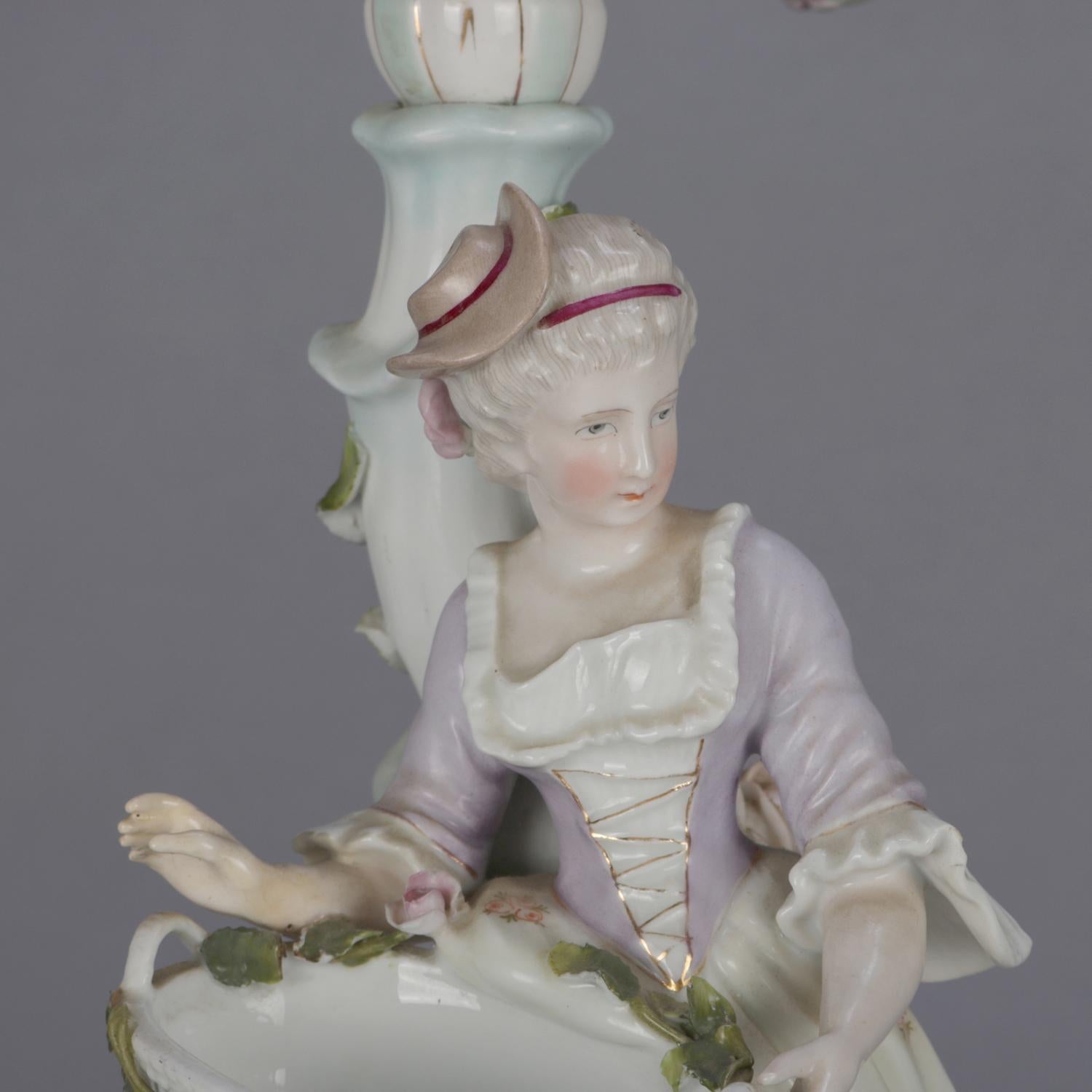 A pair of German Meissen School figural hand painted porcelain branch candelabra feature courting couple in country garden setting, applied flowers and gilt highlights throughout, each with five candle sockets, circa 1880.

Measures: 21