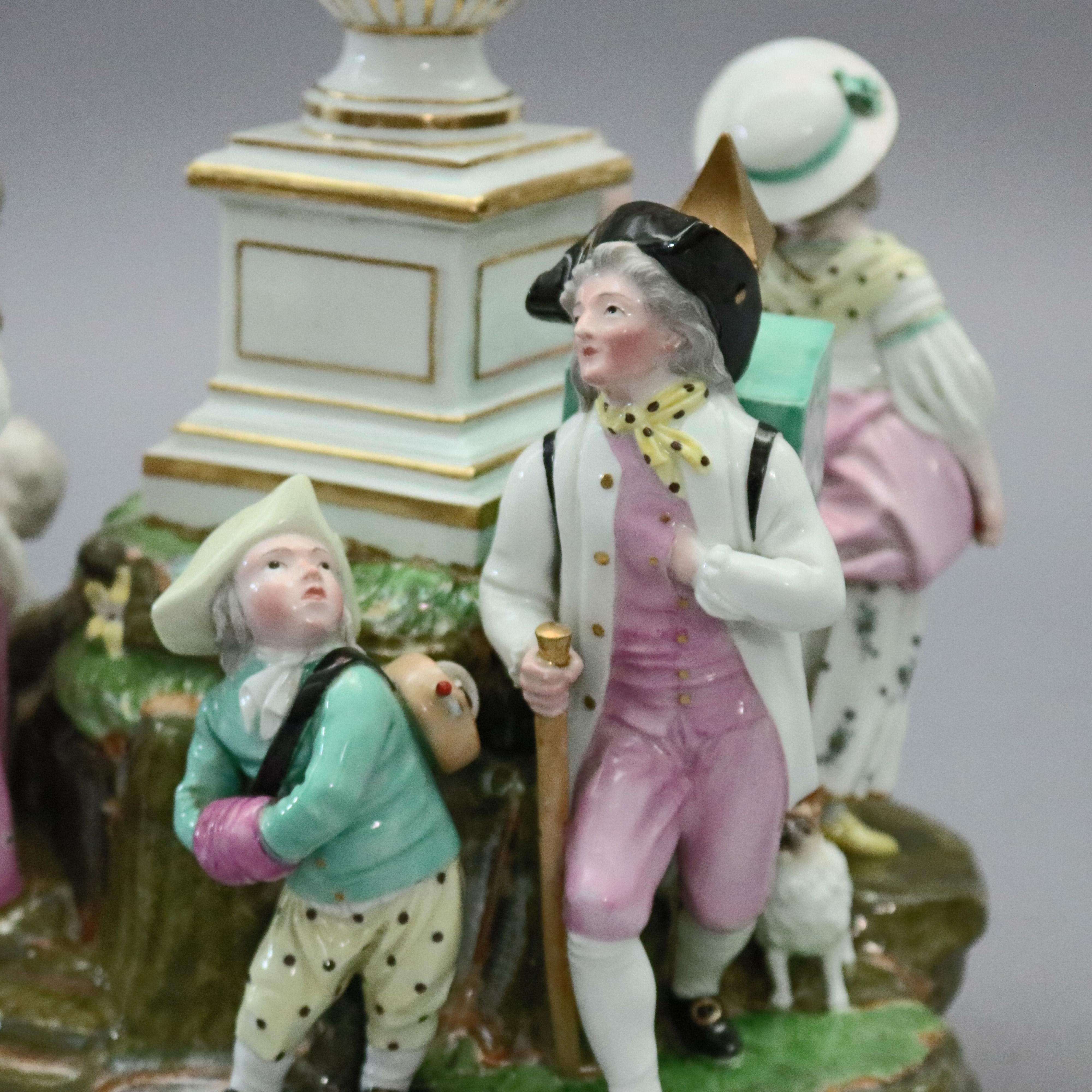 An antique Meissen School figural grouping depicts countryside genre scenes surrounding central urn including courting couple, boys on the way to market or school, and children, circa 1880.

Measures: 11.25