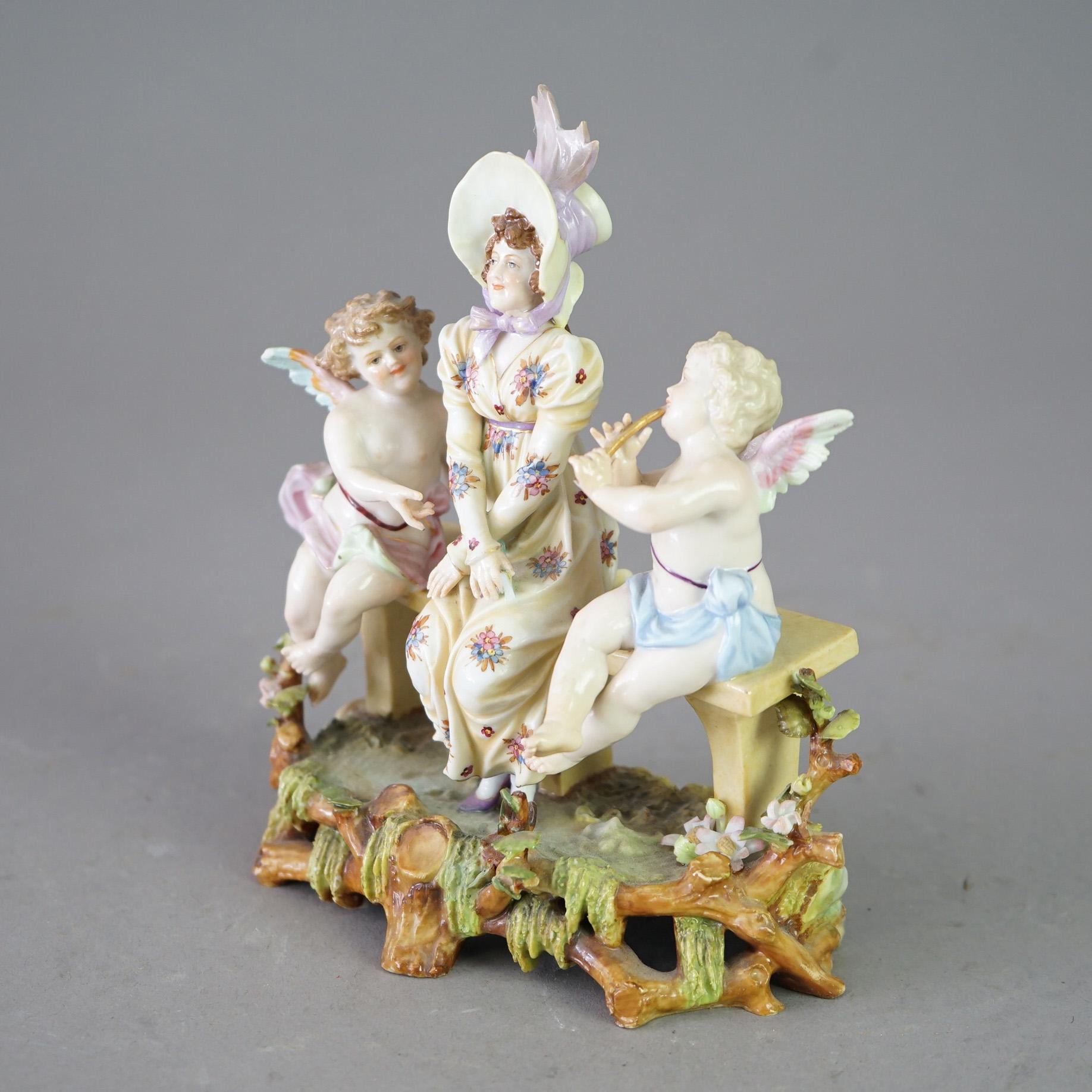 An antique German figural grouping in the manner of Meissen offers cherubs and young woman in countryside setting, hand painted with gilt highlights; maker stamp as photographed; 20th century

Measures - 6.75
