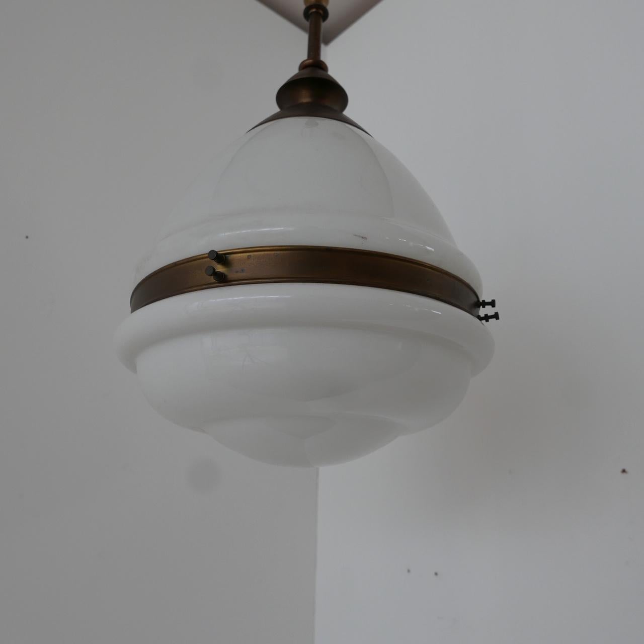 Early to mid-20th century German opaline pendant light,

White opaline glass with a patinated brass rim and gallery.

Re-wired and PAT tested.

There is an internal chip around the brass rim, not visible from the outside but worth noting. It