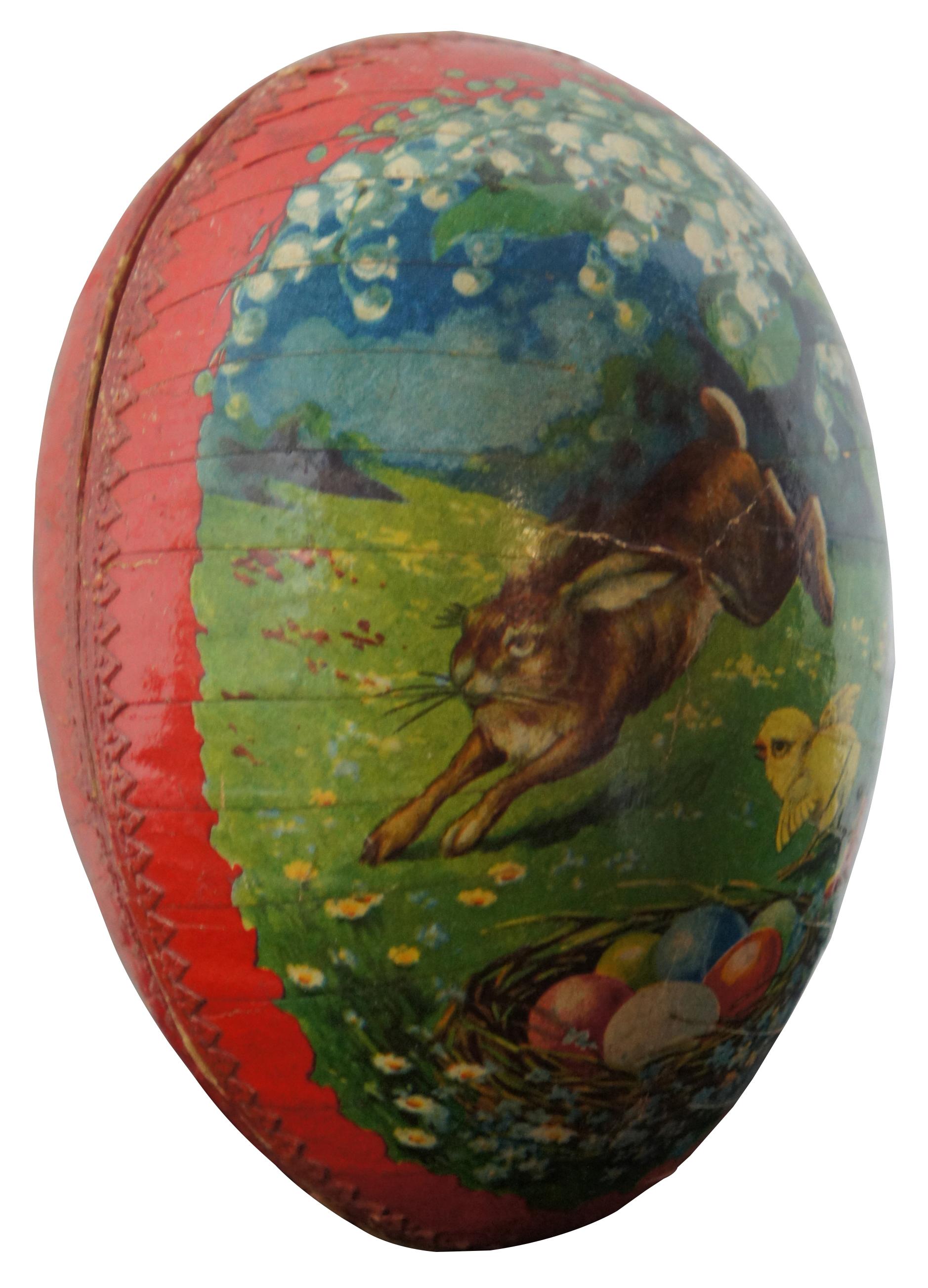 Antique German papier mâché Easter egg candy container, featuring a lithograph landscape of a rabbit leaping beneath lily of the valley blossoms, past a chick by a nest of Easter eggs. Measure: 5