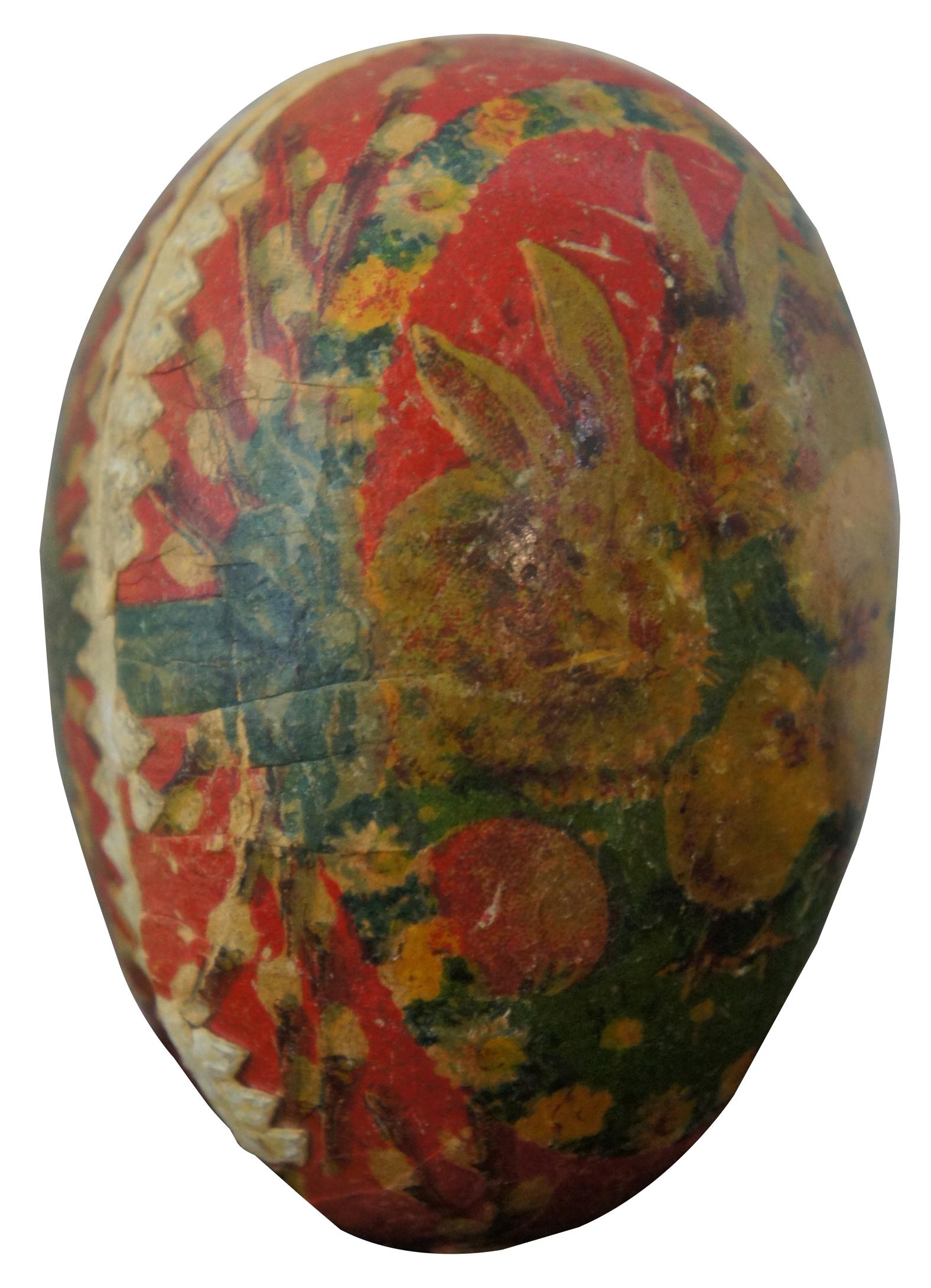 Antique German papier mâché Easter egg candy container, featuring a lithograph landscape of rabbits and chicks in a frame of flowers. Measure: 3”.