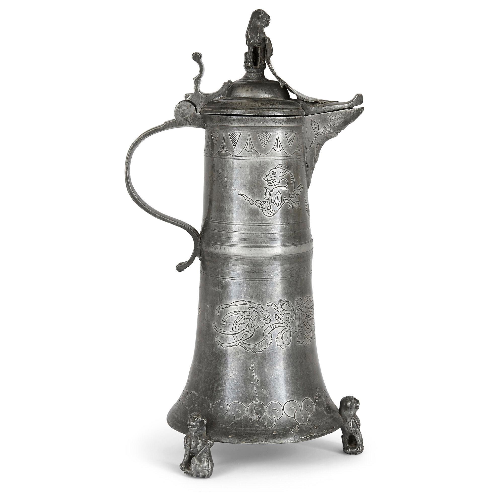 Antique German pewter jug
German, early 19th Century
Height 40cm, width 17cm, depth 20cm

This German pewter ewer is of traditional form, featuring a long body that is broader at the base than top, three lion feet, a loop handle, and a hinged