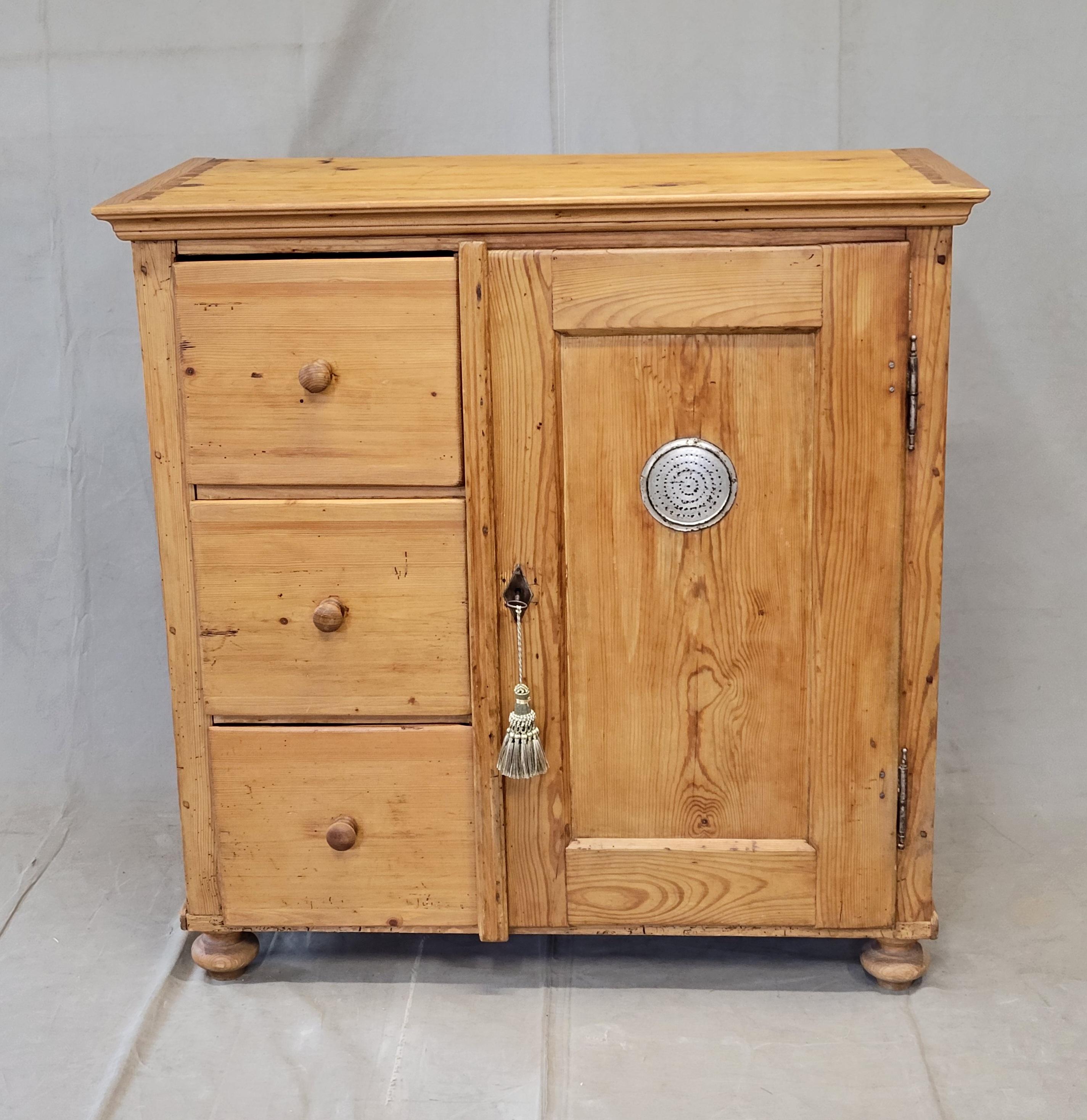 A beautiful, rustic antique pine larder or pie cabinet cupboard that dates from the late 1800s in Germany. These cabinets were used in kitchens throughout eastern Europe, for food storage. It is in good condition for its age and has recently been