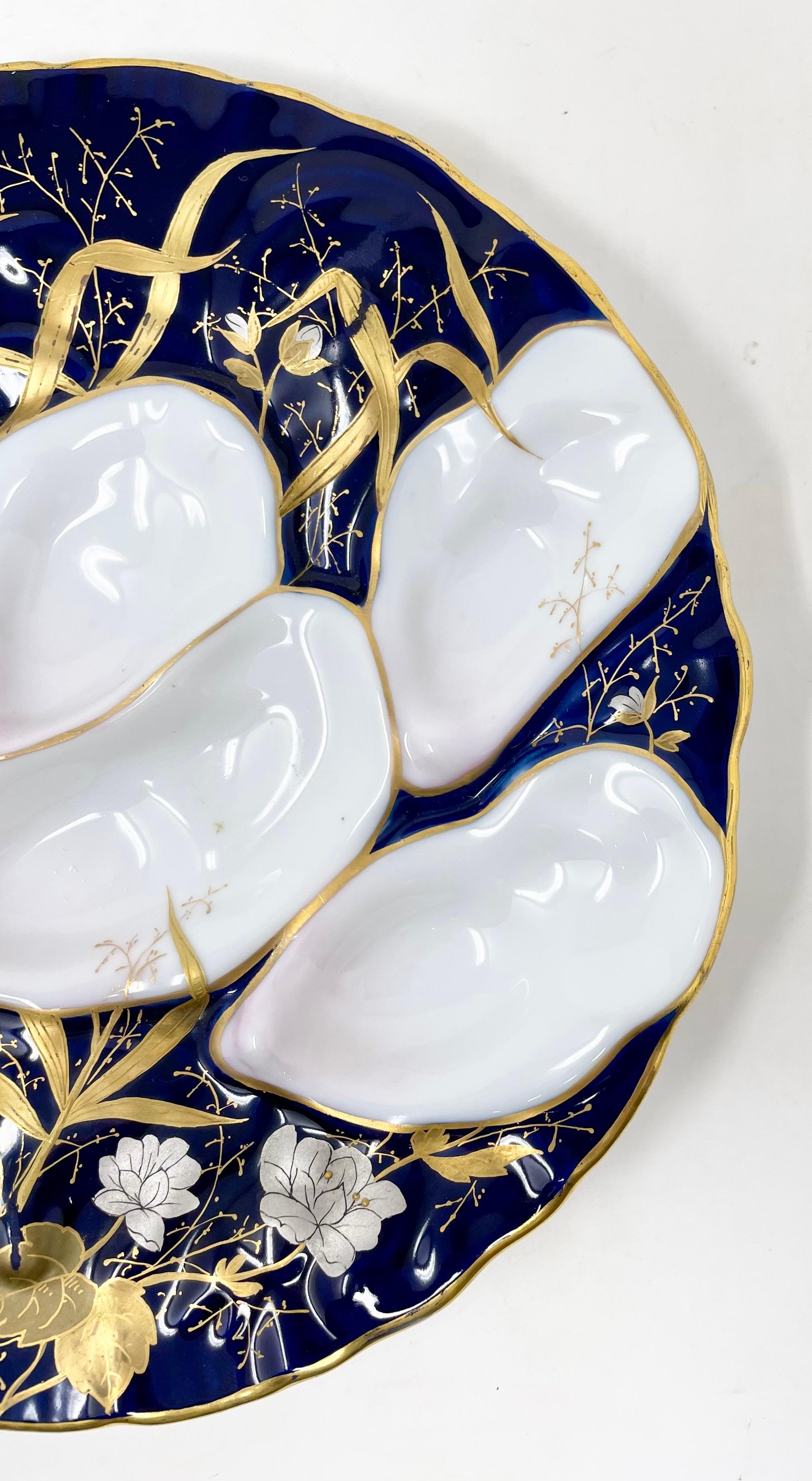 Antique German Art Nouveau Design Hand-Painted Porcelain Turkey Pattern Oyster Plate, Circa 1900.
Beautiful design of sea grasses and flowers in cobalt blue, periwinkle, gold and white.