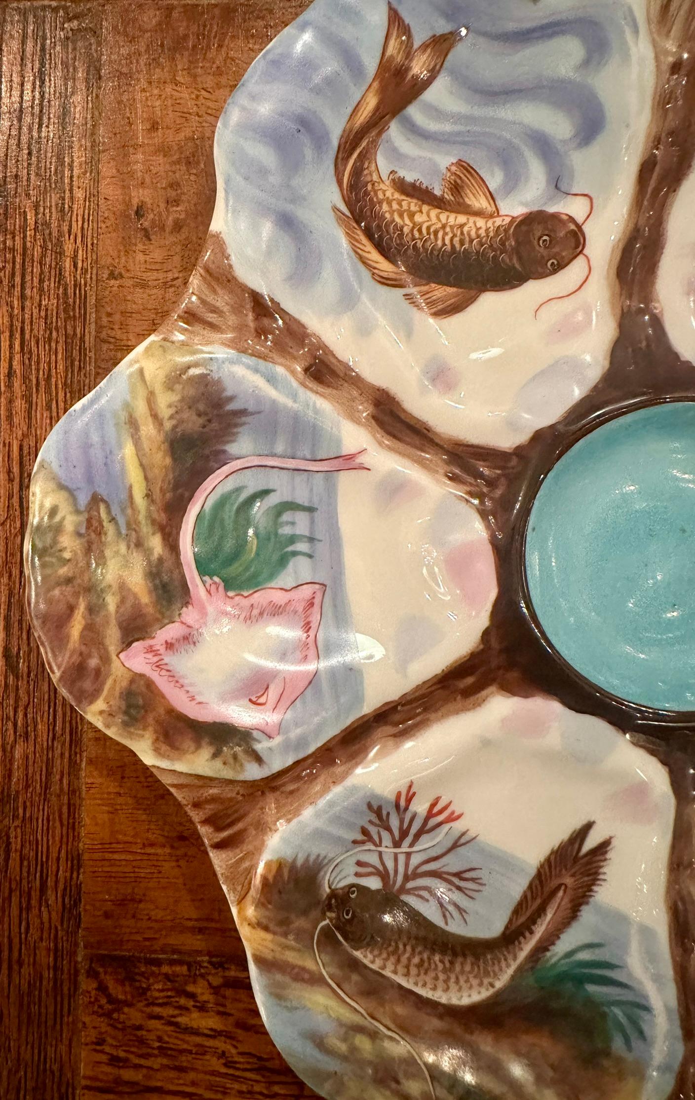 Antique German porcelain shaped oyster plate with colorful hand-painted
sea life, circa 1890's.
Vibrant colors of blue, green, red, orange, pink & umber.