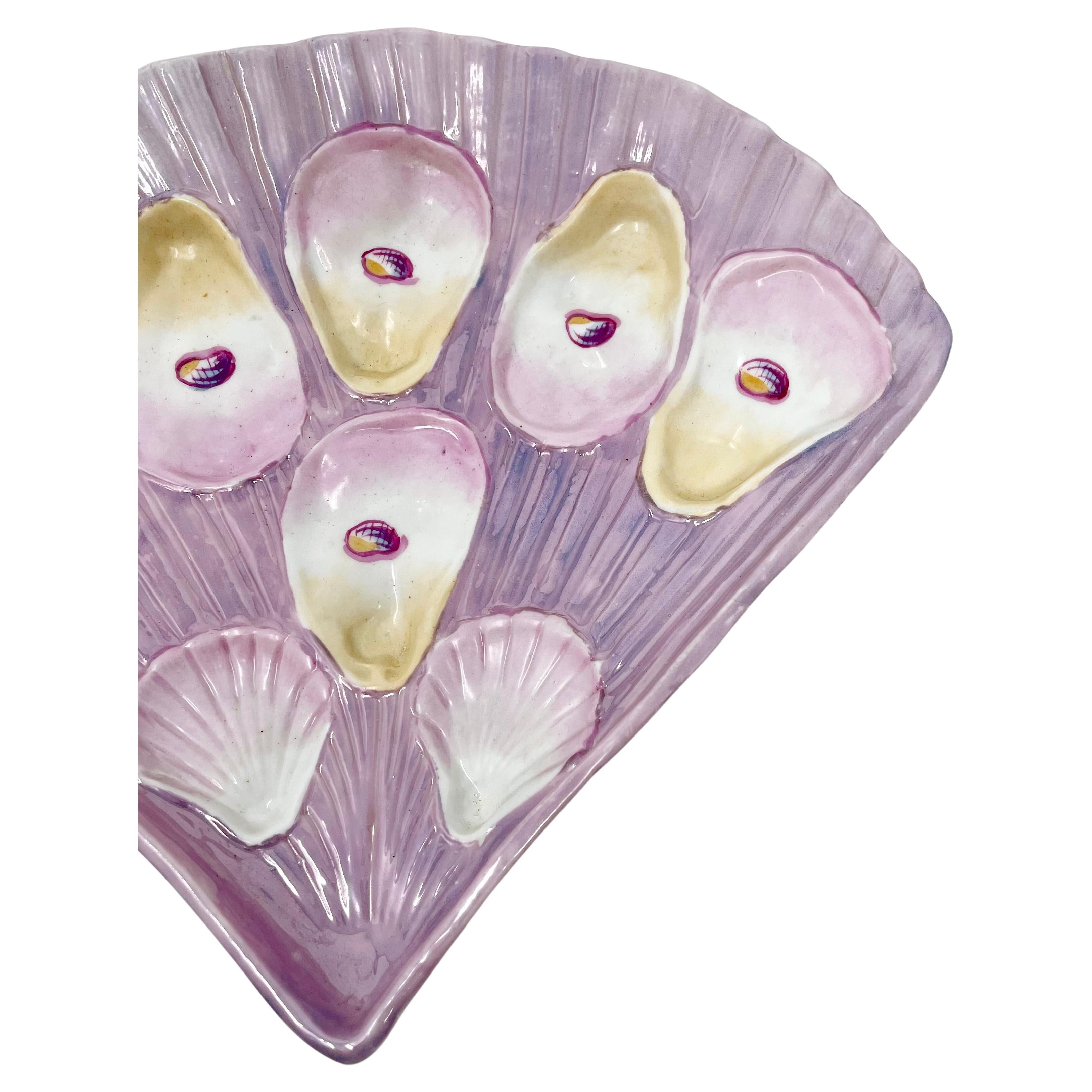 Rare antique German porcelain fan-shaped pink luster oyster plate, circa 1890.
This plate is stunning with a purplish pink pearlized glaze.