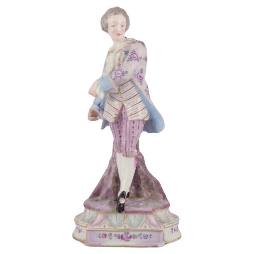 Antique German porcelain figurine of young man in fine clothes. For Sale