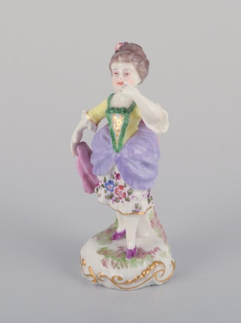 Antique German porcelain figurine. 
Young woman in elegant attire. Hand-painted in polychrome colors.
19th century.
Marked.
In excellent condition, except for missing left thumb.
Dimensions: Height 11.5 cm x Diameter 5.5 cm.