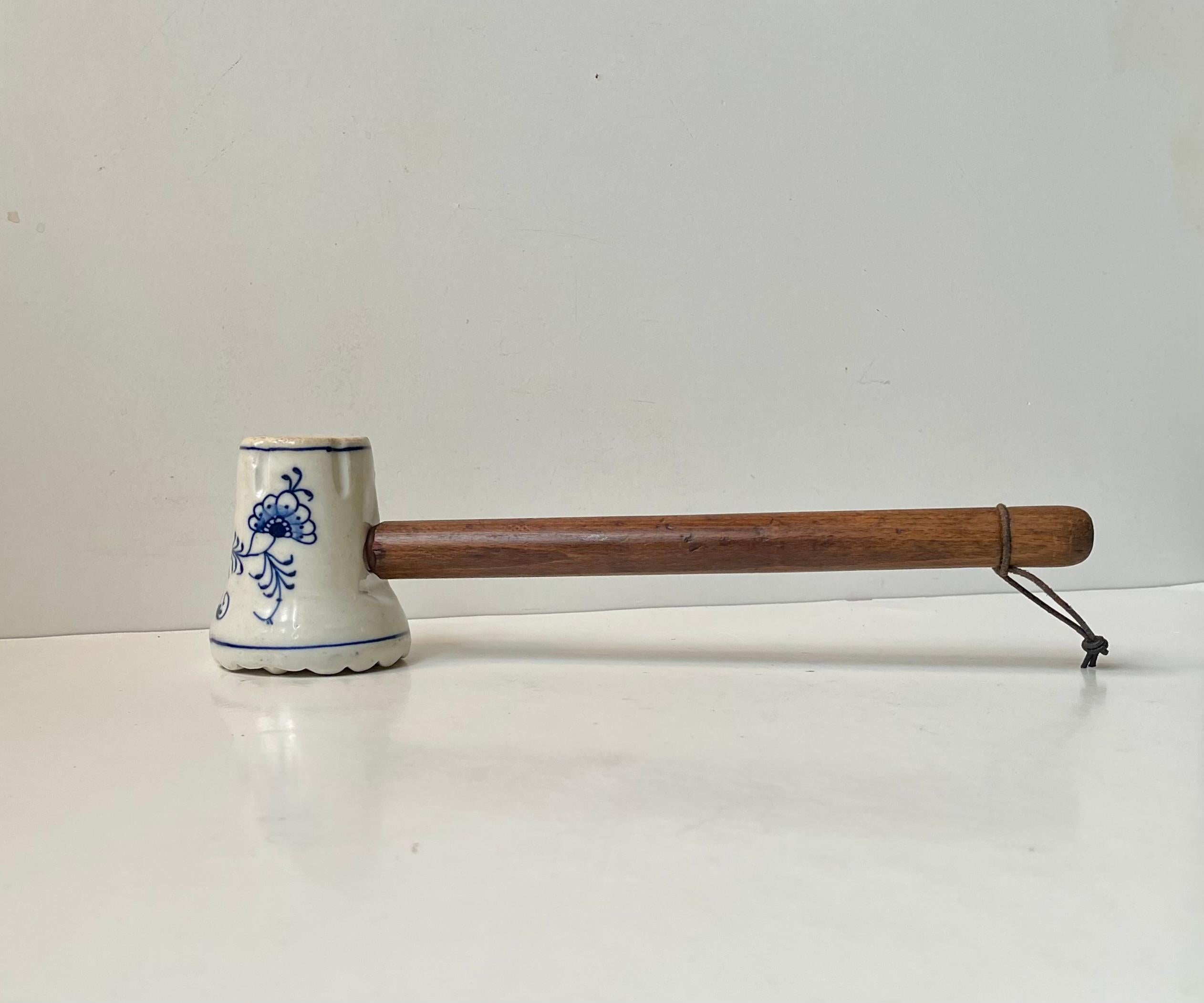 Large decorative and useable meat hammer/mallet in ironstone porcelain. Hand-glazed/painted in Onion pattern and made by either Meissen or Teichert in Germany circa 1890-1910. It is equipped with a patinated oak handle with leather strop.
