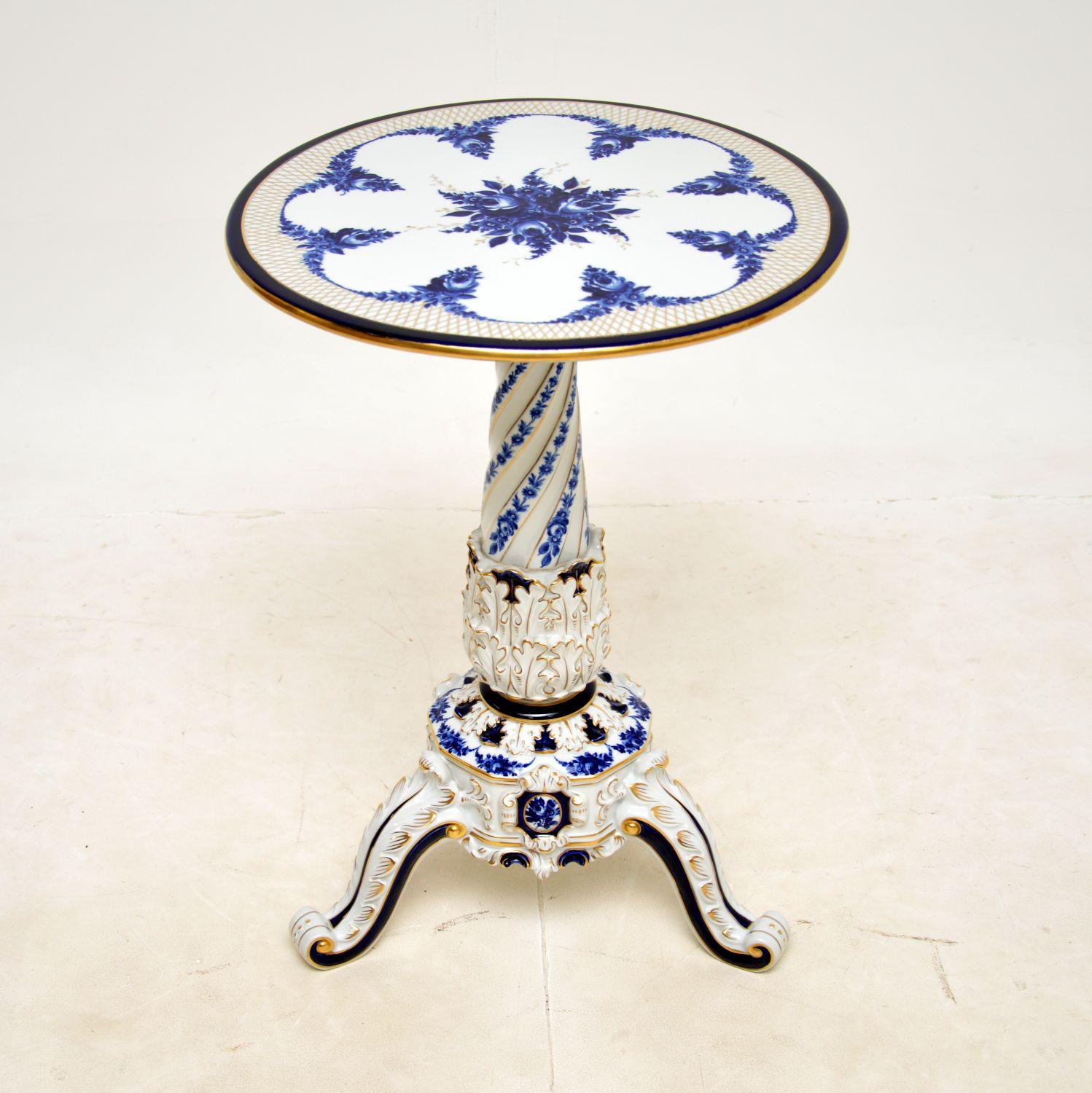 A stunning vintage German porcelain tripod table. This was made in Germany by Von Schierholz, it dates from around the 1960s.

The quality is outstanding, this is beautifully made, with amazing details throughout. The hand painted blue and gold