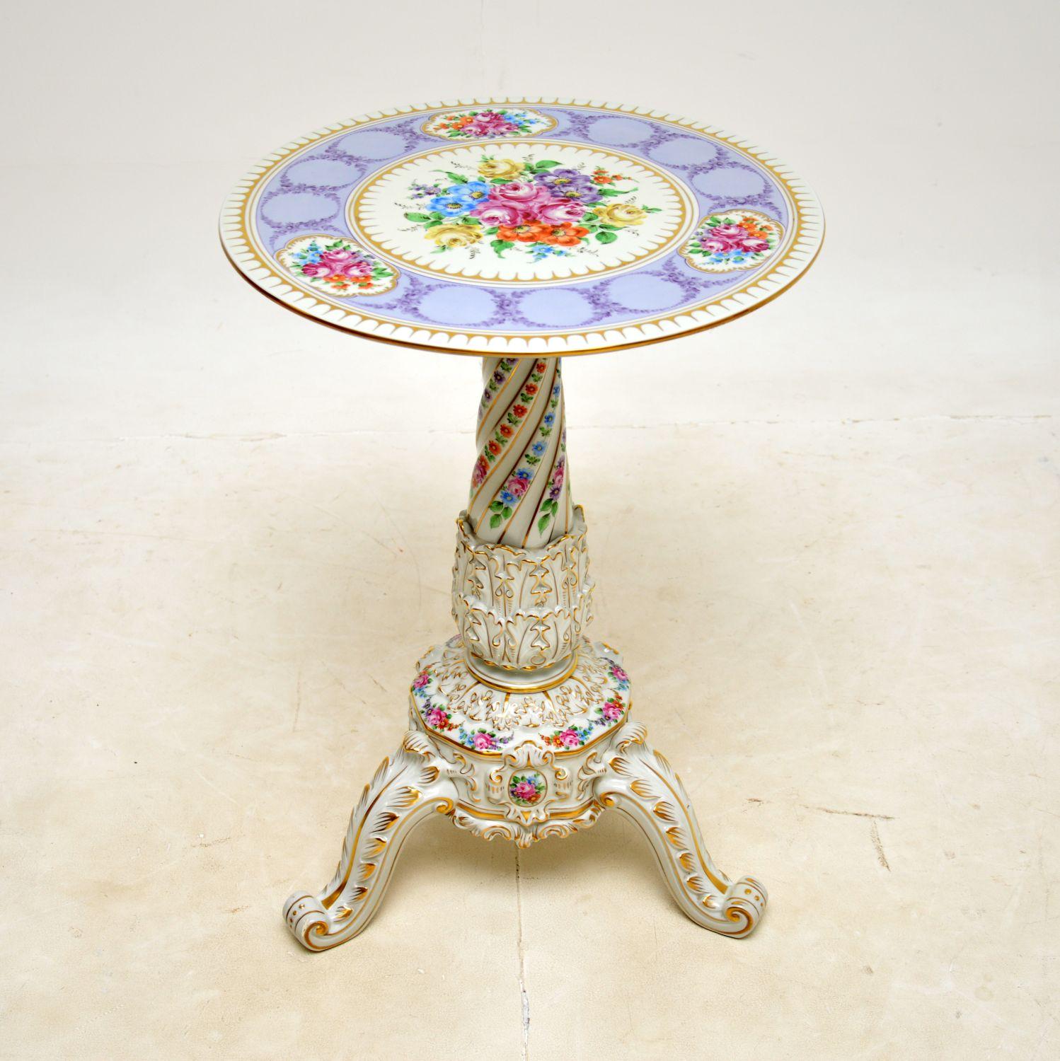 A stunning vintage German porcelain tripod table. This was made in Germany by Von Schierholz, it dates from around the 1960s.

The quality is outstanding, this is beautifully made, with amazing details throughout. The hand painted floral decorations
