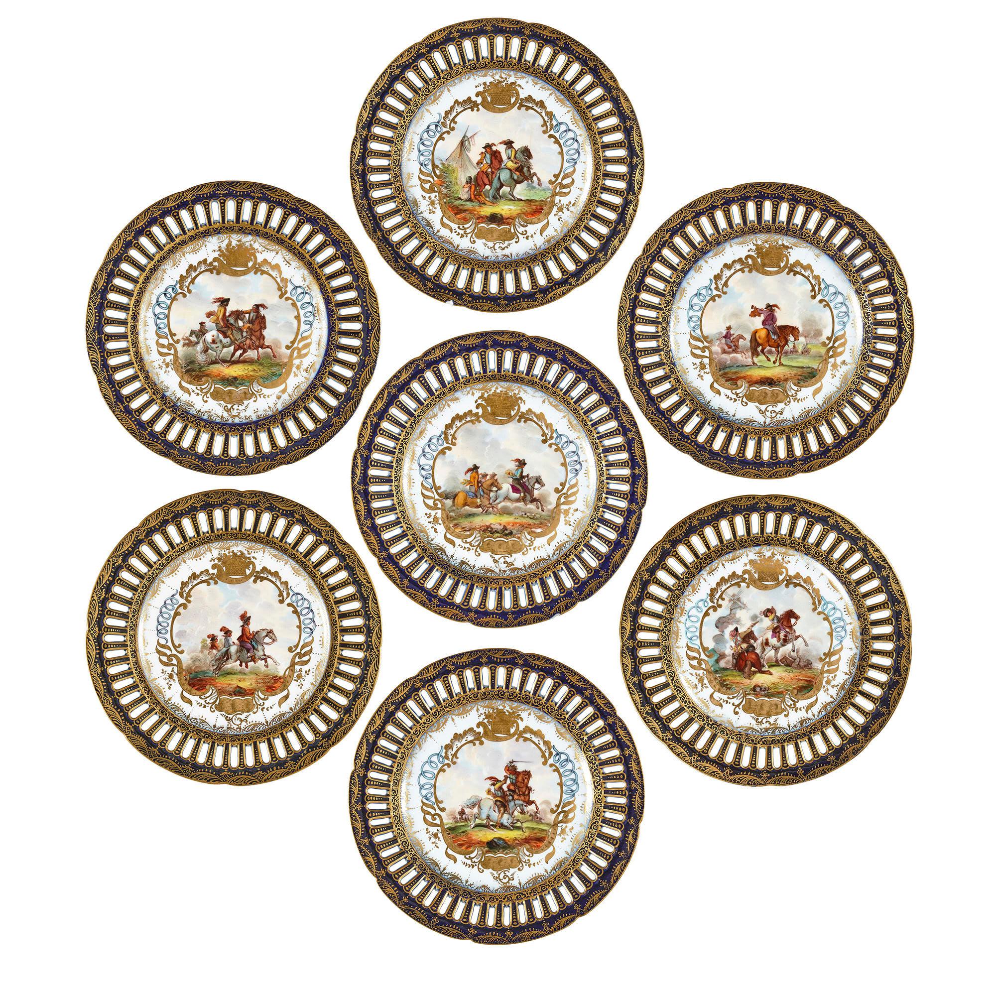 Antique German porcelain twelve piece dessert service
German, c. 1880
Measures: Seven flat plates: Height 2cm, diameter 22cm
Four raised plates: Height 6.5cm, diameter 25cm
Larger raised plate: Height 10cm, diameter 25cm

This fine, regal