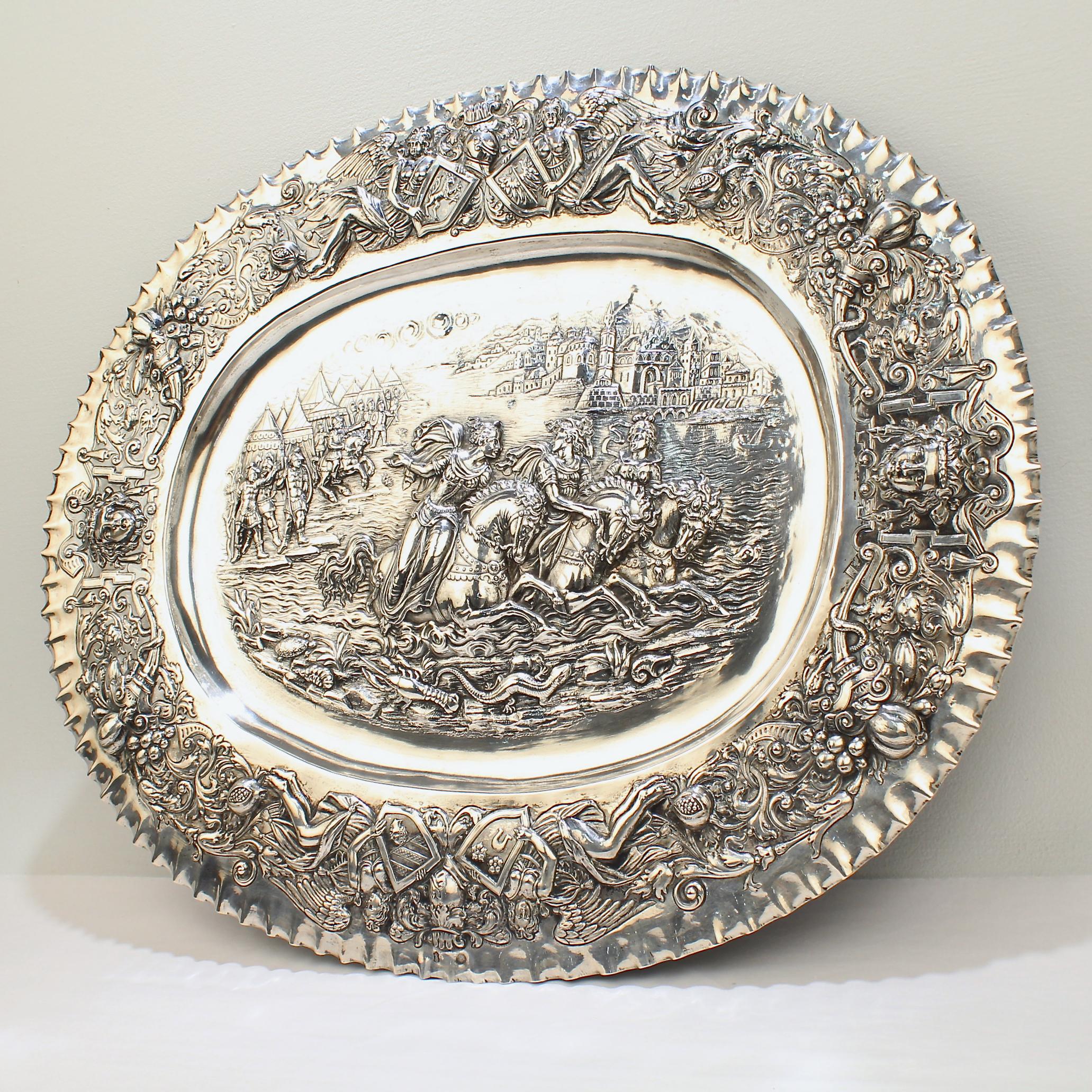 A very fine German Renaissance Revival or 'Gründerzeit' silver tray.

Decorated with an incredible tour-de-force of repousse decoration that is centered around a large scene with 3 maidens escaping on horseback from a Roman Soldier encampment across